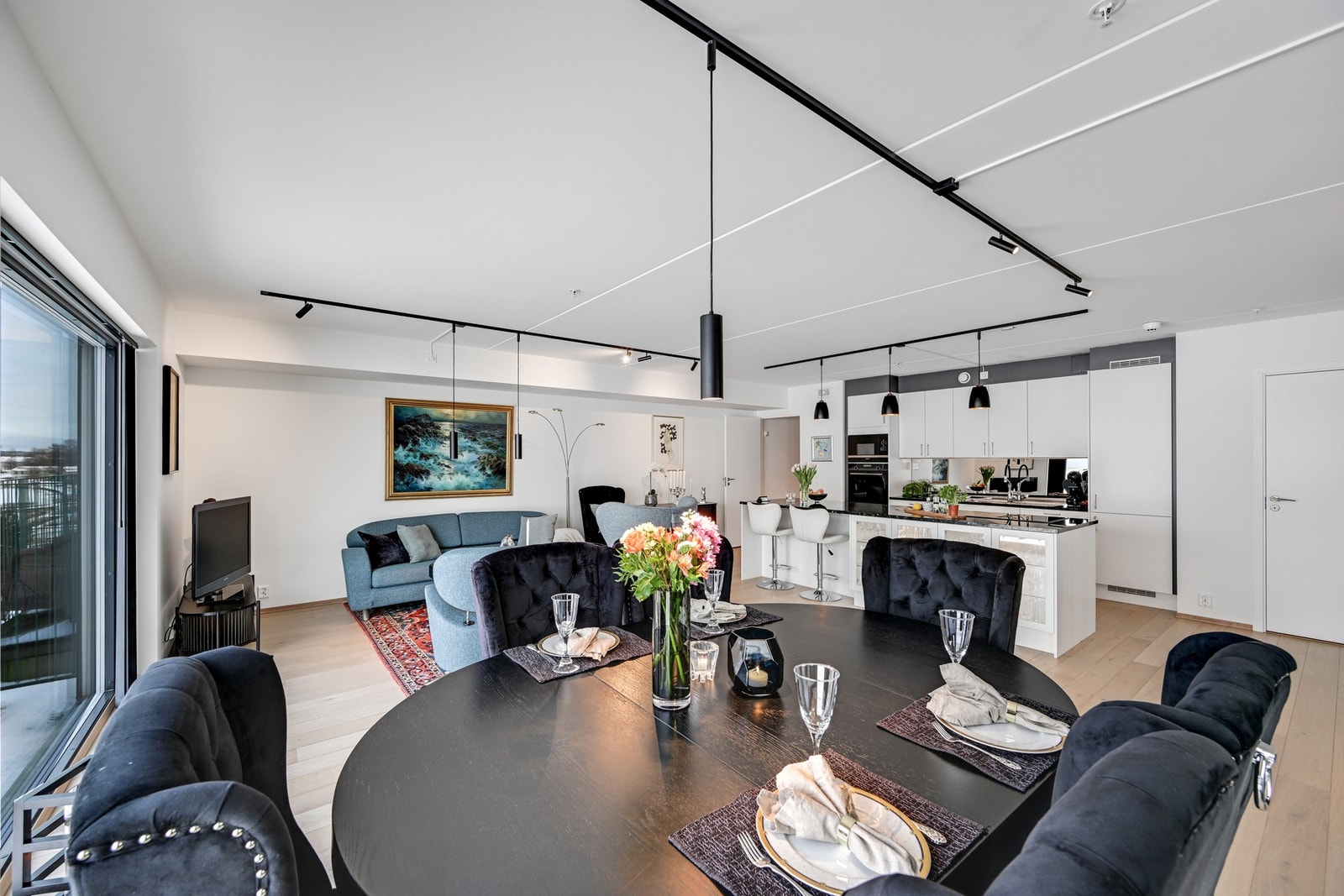 Åpen kjøkken- og stueløsning med en praktisk barløsning hvor dagens første kaffekopp kan inntas Galleribilde