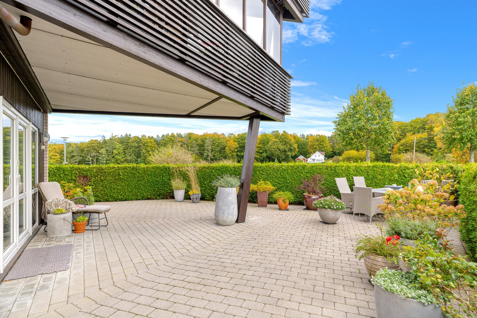 Leiligheten disponerer et stort uteområde belagt med brostein. Her er det trapp ned til sameiets fantastiske felleshage Galleribilde