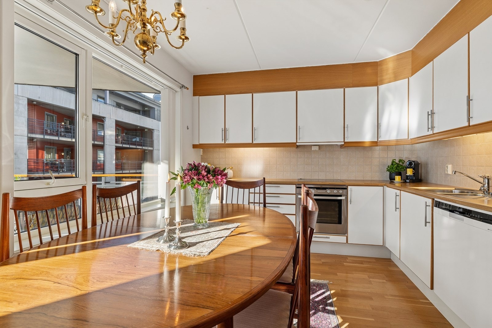 Kjøkkenet fra byggeår er pent og funksjonelt, med slette fronter, laminert benkeplate og fliser over benk. Galleribilde