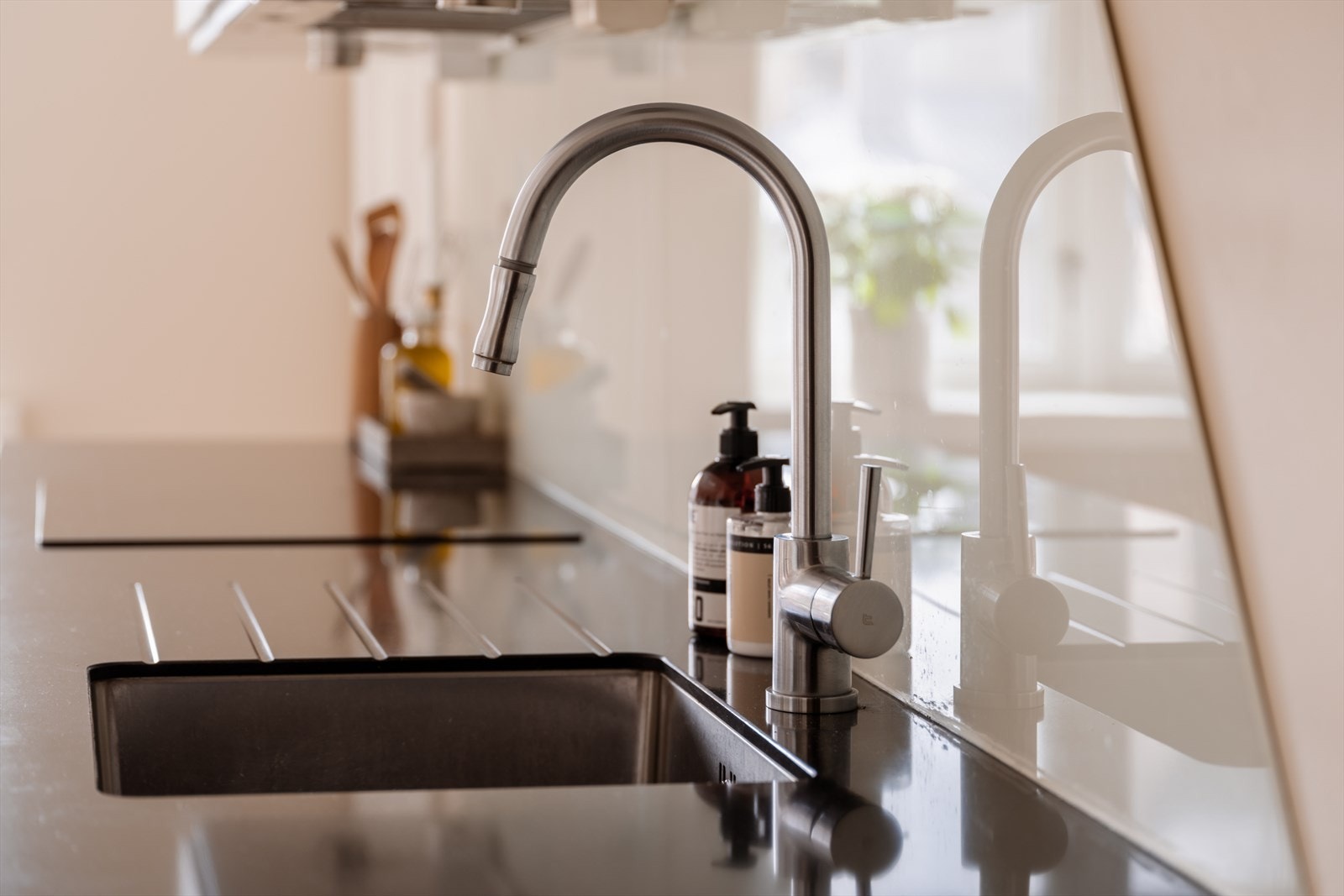 Benkeplaten i stein med nedfelt vask gir en funksjonell og slitesterk arbeidsflate. Galleribilde