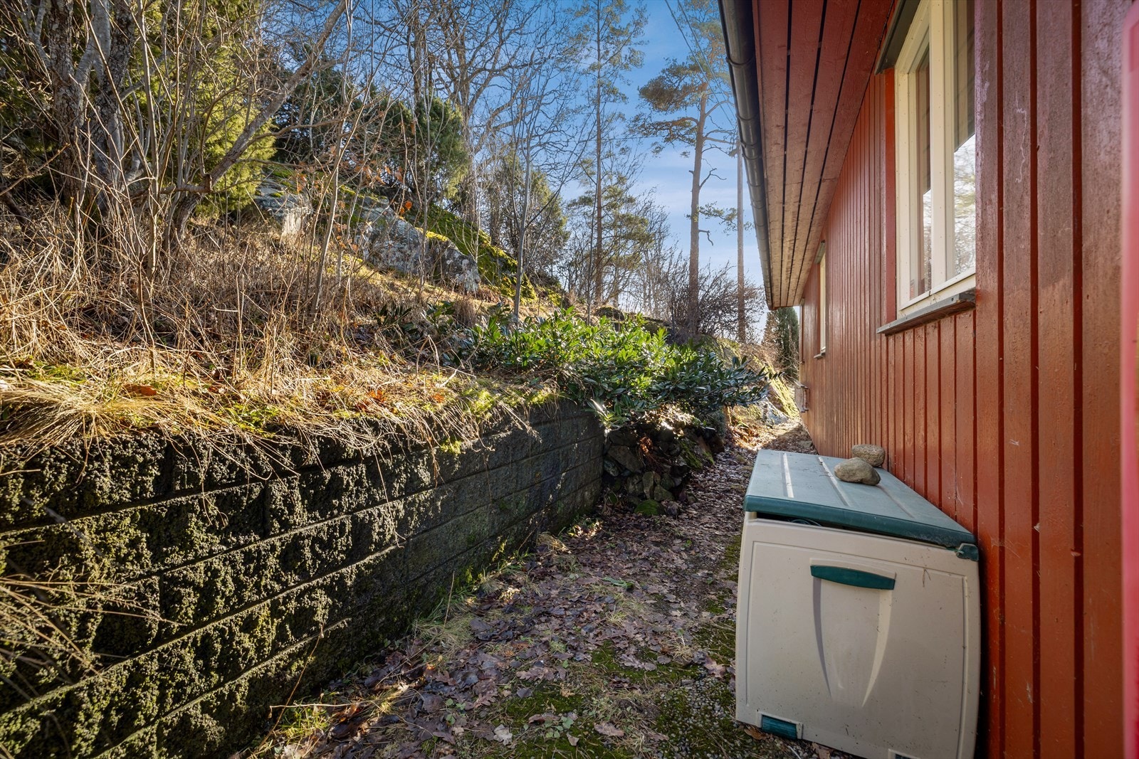 Eiendommen har støttemur av Leca og yttervegger med stående trekledning. Galleribilde
