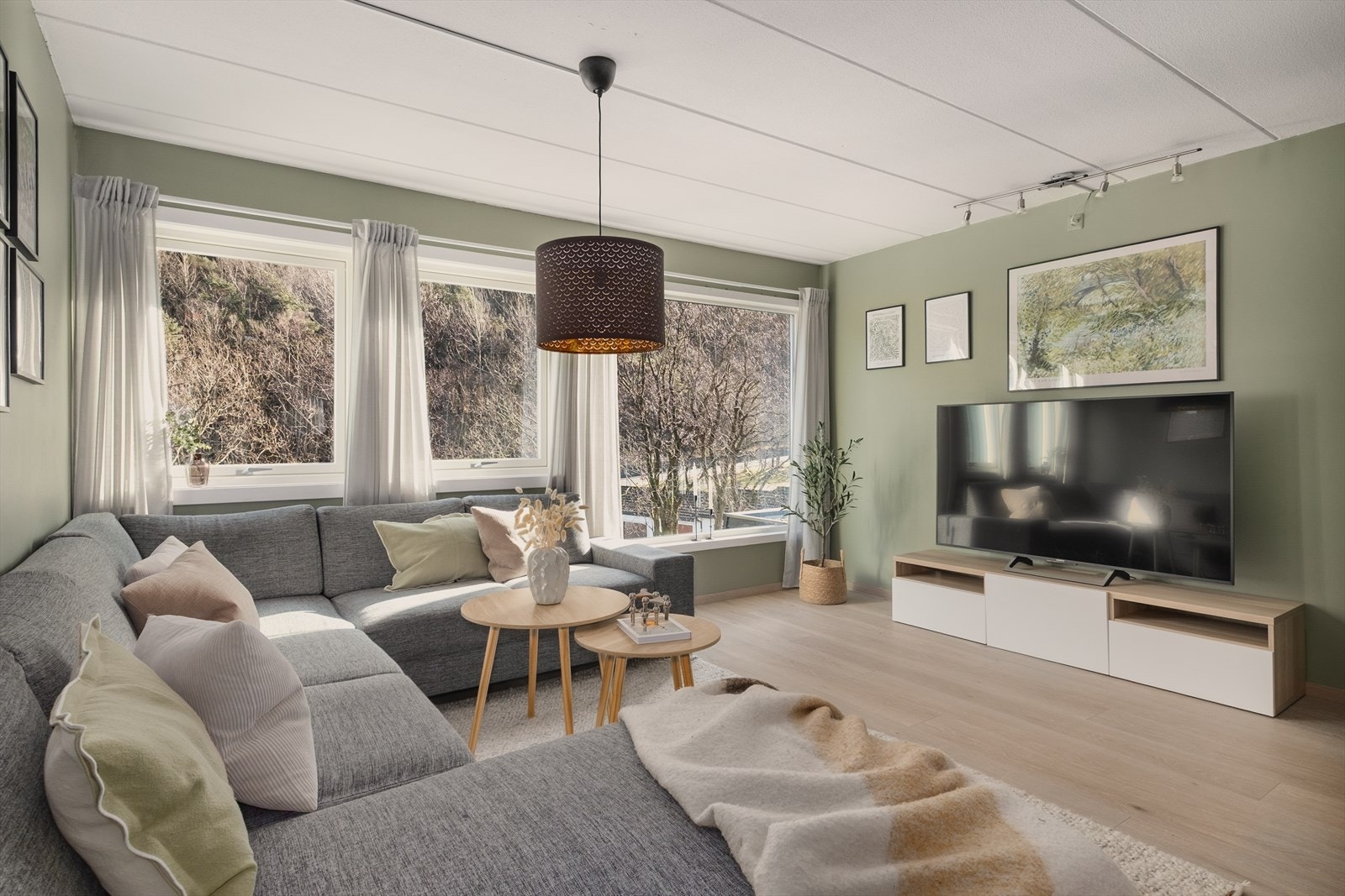 Stuen er lys og innbydende. Rolige fargetoner og naturlige materialvalg skaper en behagelig stemning. Galleribilde