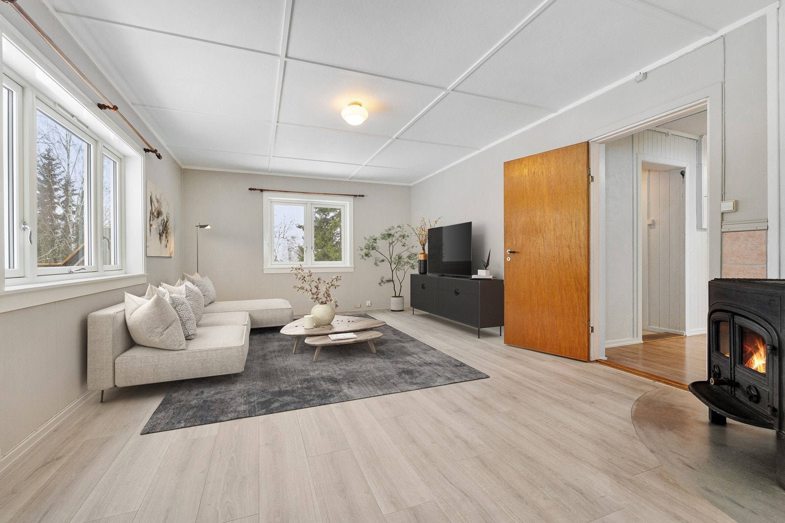 Romslig stue med god plass til sofamøblement og TV-bord. Bildet er digitalt stylet. Galleribilde