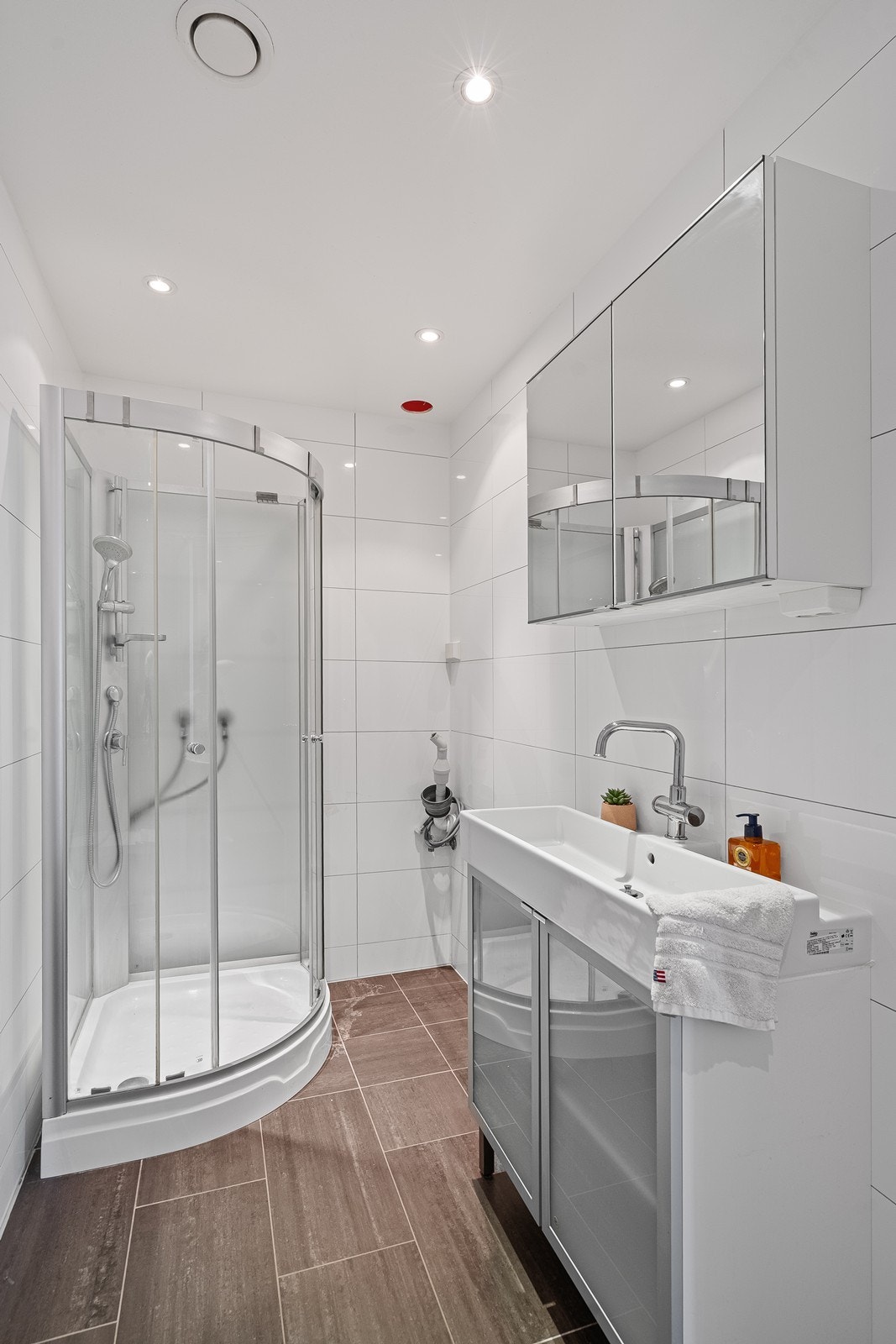 Helfliset bad i kjeller med spotter i tak, dusjkabinett samt opplegg til vaskemaskin/tørketrommel Galleribilde