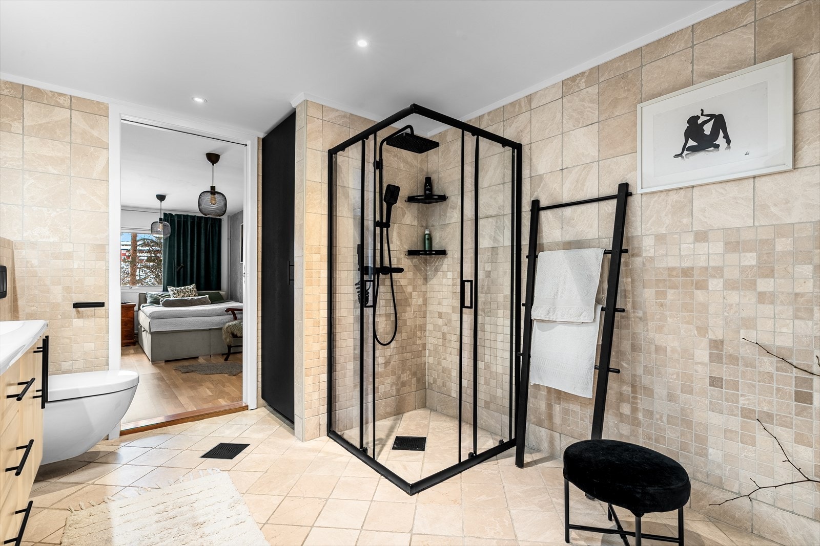 Badet har et moderne dusjhjørne med glassdører og et vegghengt toalett. Galleribilde