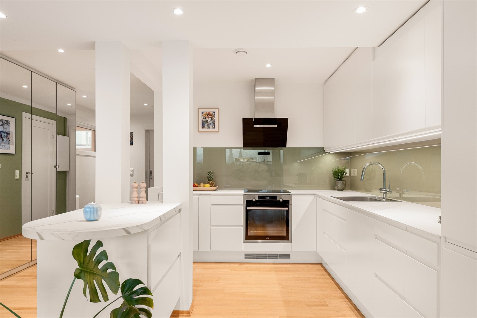 Moderne Epoq-kjøkken med glatte fronter og slitesterk laminatbenkeplate. Downlights i himling med dimmer. Galleribilde