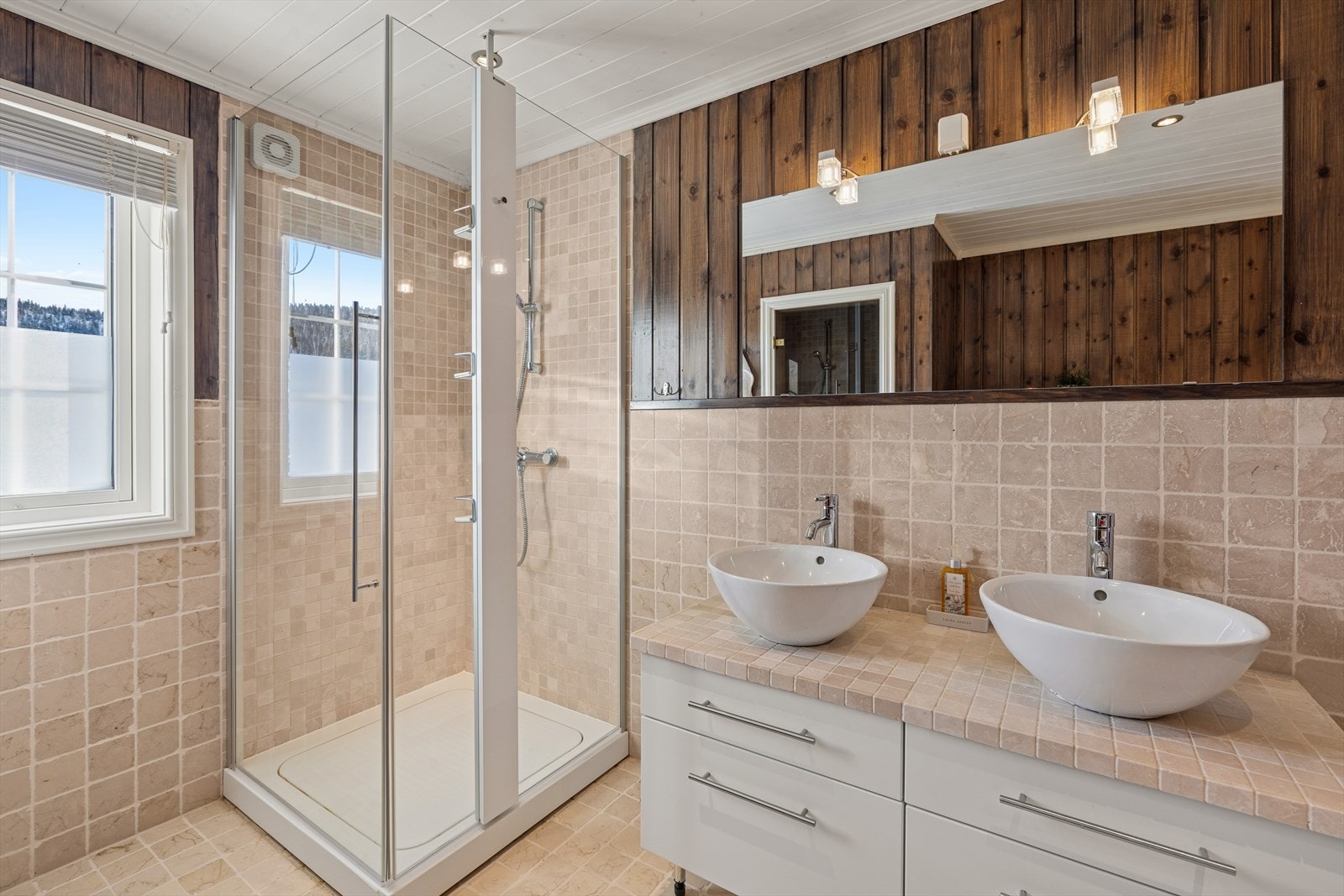 Badet er fra byggeår, med fliser på gulvet og en kombinasjon av fliser og panel på veggene. Det er behagelig gulvvarme. Galleribilde