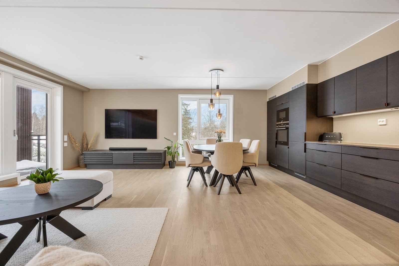 Fra gangen åpner leiligheten seg opp mot det store allrommet for stue og kjøkken. Galleribilde