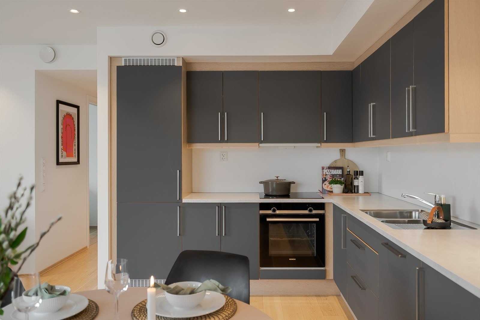 Moderne HTH -kjøkken med glatte fronter og detaljer i hvitpigmentert eik. Integrerte hvitevarer. Galleribilde