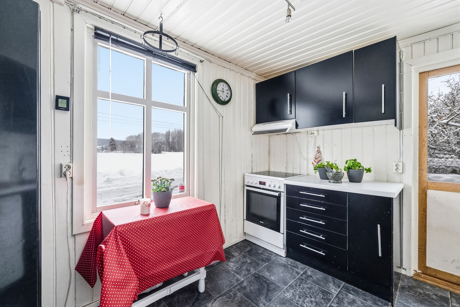 Fra kjøkkenvinduet er det utsikt mot det åpne landskapet rundt eiendommen. Et lite spisebord ved vinduet gir mulighet for morgenkaffe med utsikt - kanskje mens man funderer på hvordan drømmekjøkkenet skal bli. Galleribilde