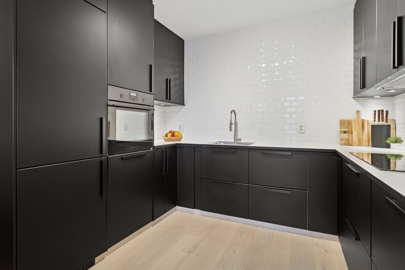 Kjøkkenet i leiligheten er utformet med fokus på både estetikk og funksjonalitet. Her møter moderne design praktiske løsninger som gjør hverdagen enklere. Galleribilde