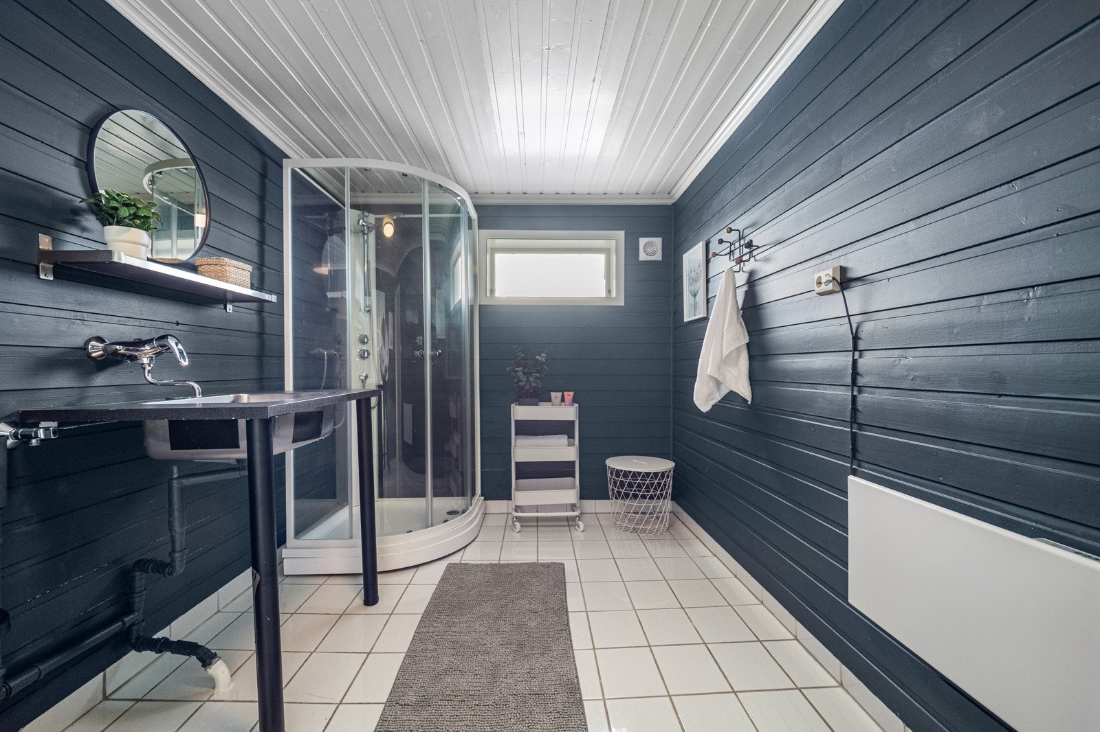 Vaskerom med opplegg for vaskemaskin, dusjkabinett og servant. Galleribilde