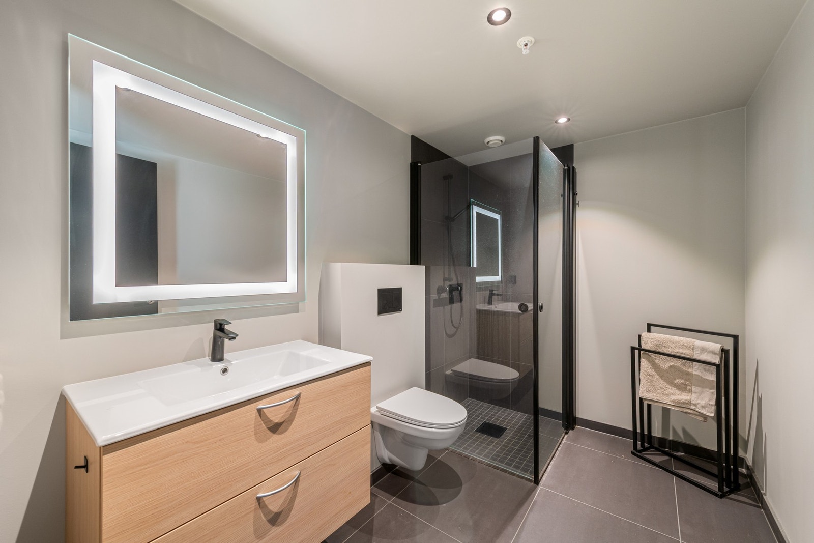 Badet er innredet med dusj, servant med innredning og toalett. Galleribilde