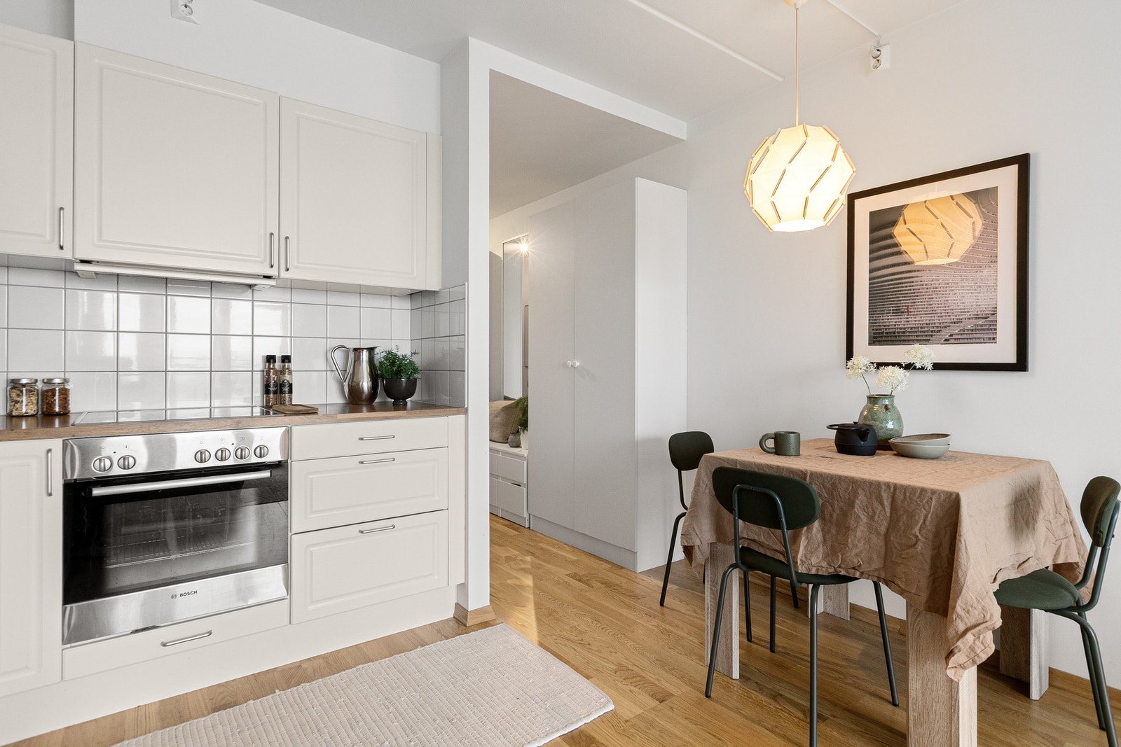 Kjøkkeninnredningen er utstyrt med benkeplate i laminat med nedfelt kum i rustfritt stål og belysning under overskap. Galleribilde