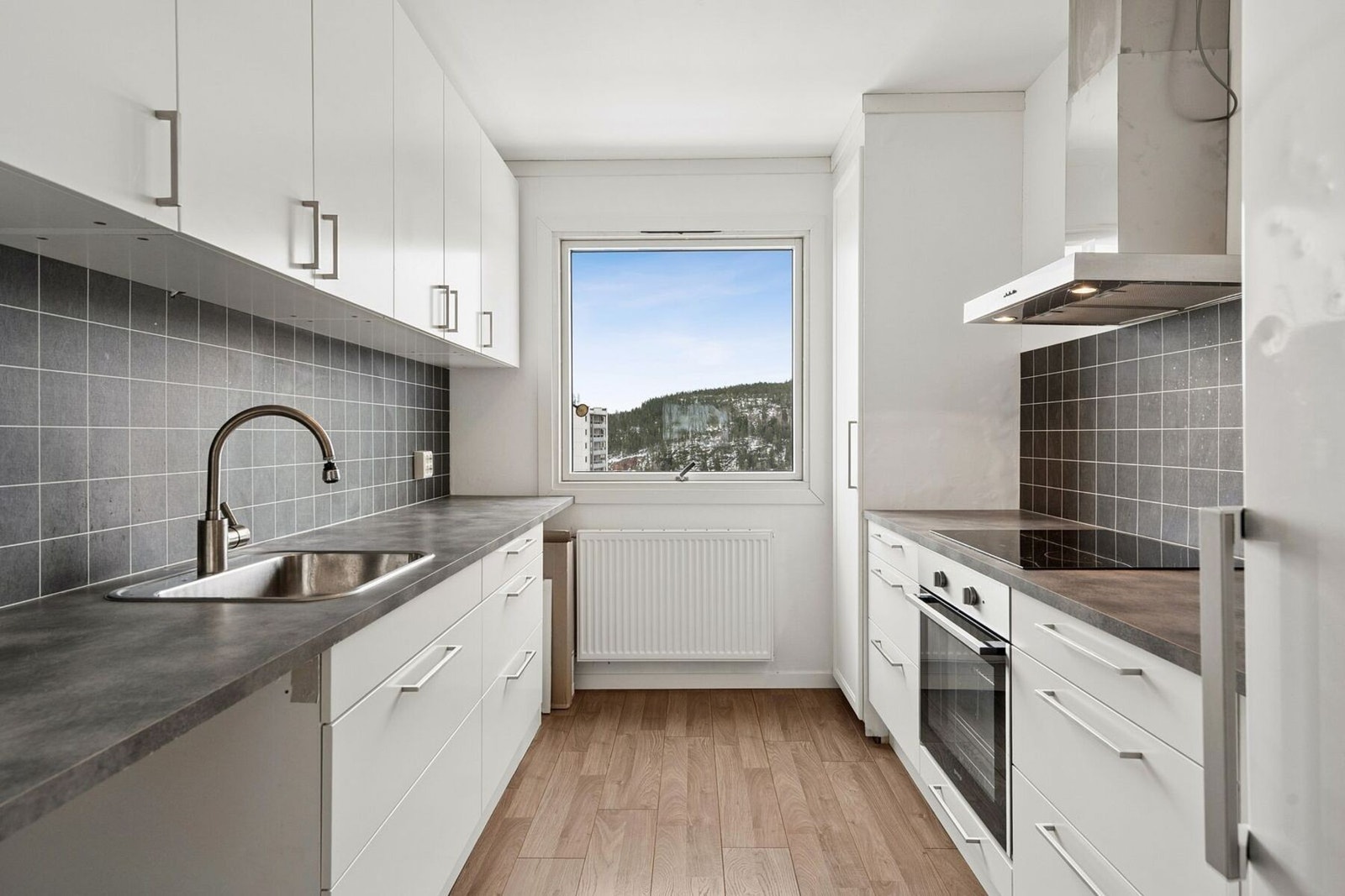 Praktisk kjøkken med innredning fra 2018, gode arbeidsflater, laminert benkeplate, nedfelt vask samt integrert stekeovn og platetopp. Galleribilde