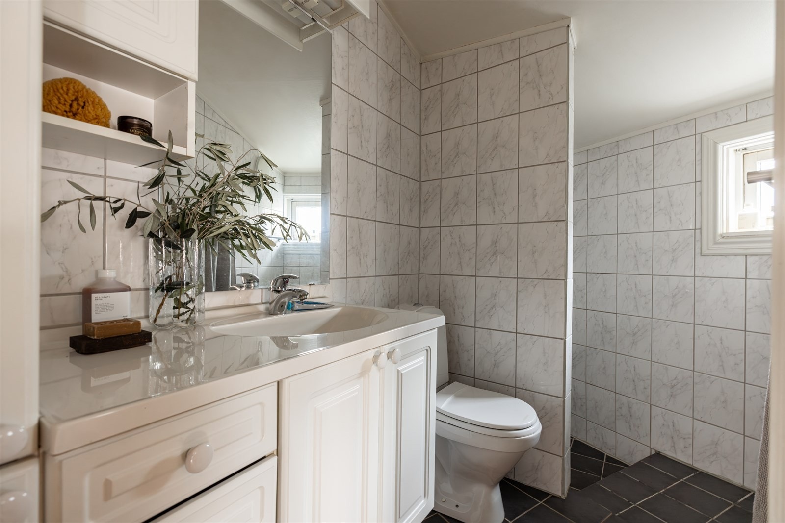 2. etasje: Flislagt, eldre bad med gulvvarme, dusjhjørne, toalett og servant i nedfelt innredning med gode oppbevaringsmuligheter. Galleribilde