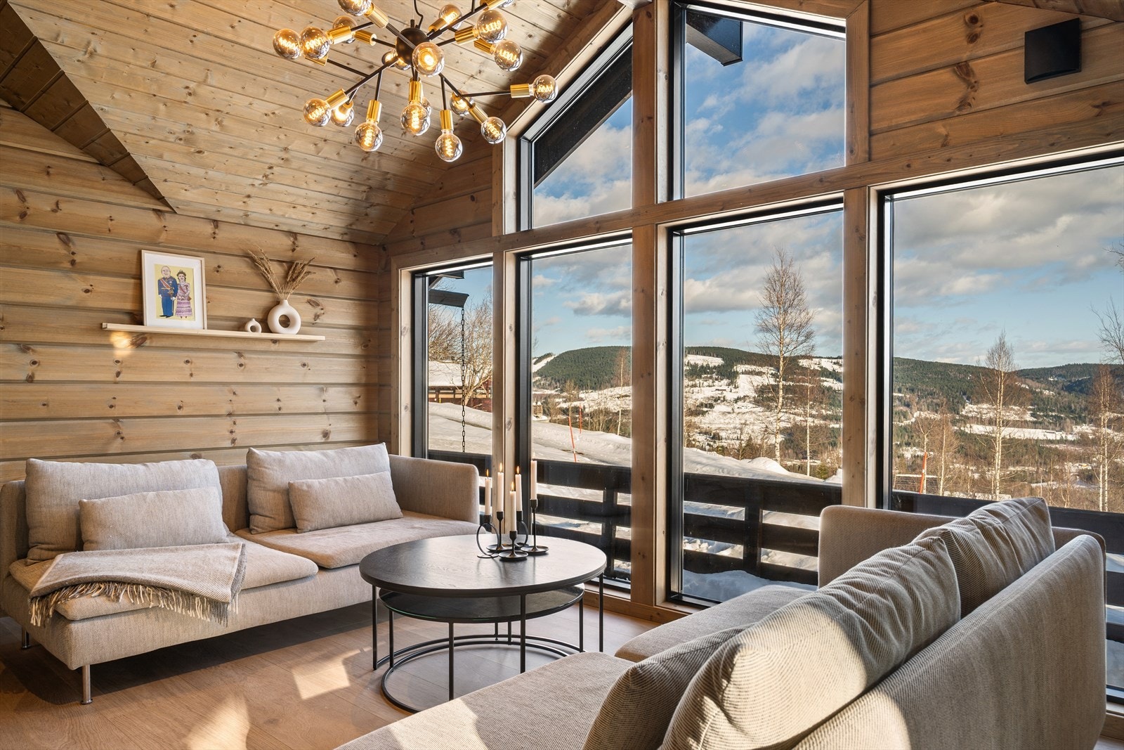 De mange vinduene gir en nærhet til naturen året rundt - enten snøen faller stille utenfor eller solen varmer over landskapet. Resultatet er en lys, luftig og særdeles hyggelig stue hvor inne- og utefølelsen smelter sammen. Galleribilde