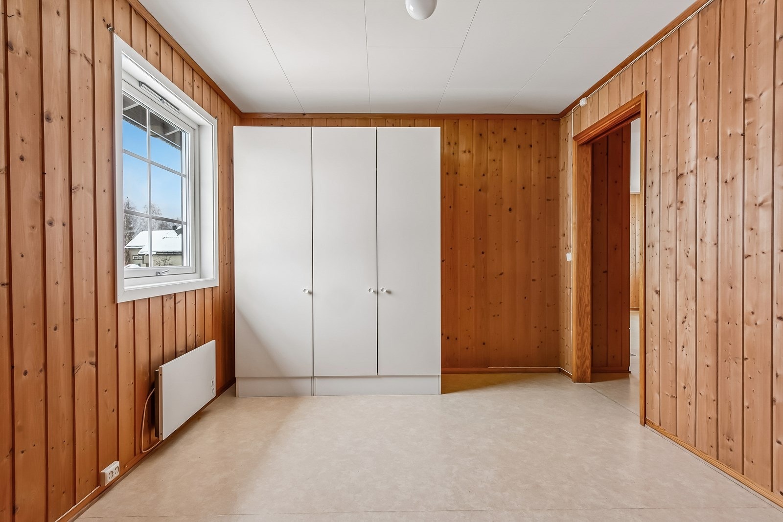 Rommet har panel på vegger og vinylbelegg på gulvet, i likhet med resten av boligen. Galleribilde