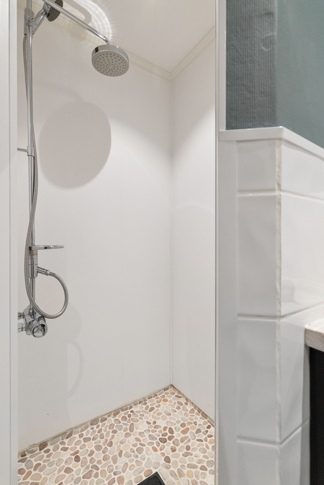 Praktisk dusjnisje med baderomsplater på veggene. Galleribilde