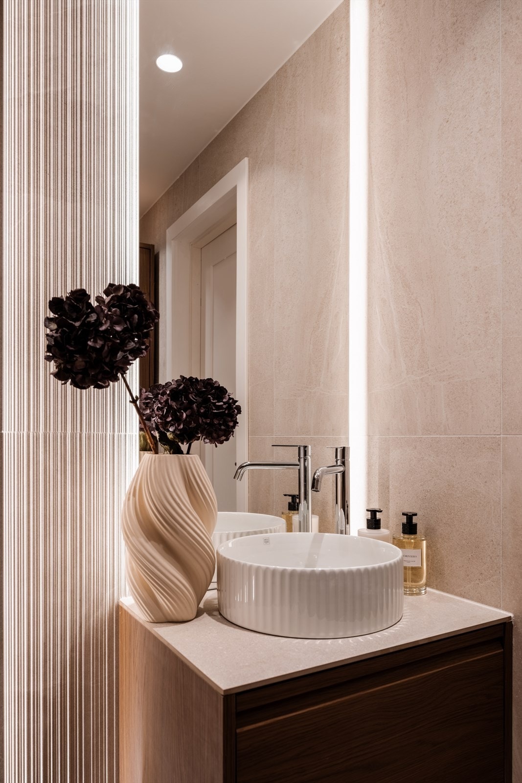 Elegant servant på en mørk innredning og et speil med integrert belysning. Galleribilde