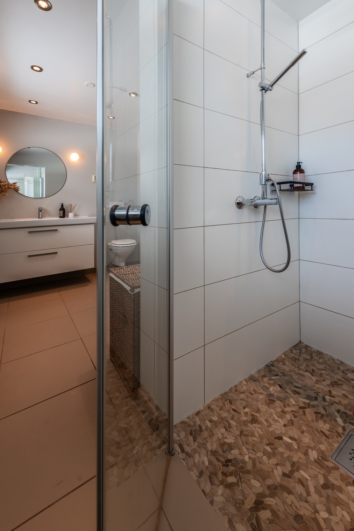 Badet har fliser på gulv og elvestein i dusjnisje, samt fliser på vegger i dusjnisje Galleribilde