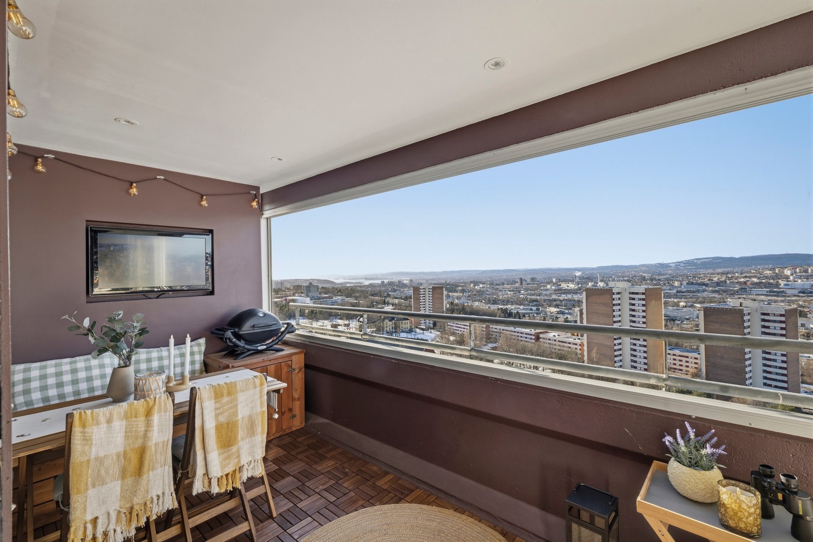 Balkongen har en fin nisjehylle med TV og gulv med tremmer Galleribilde