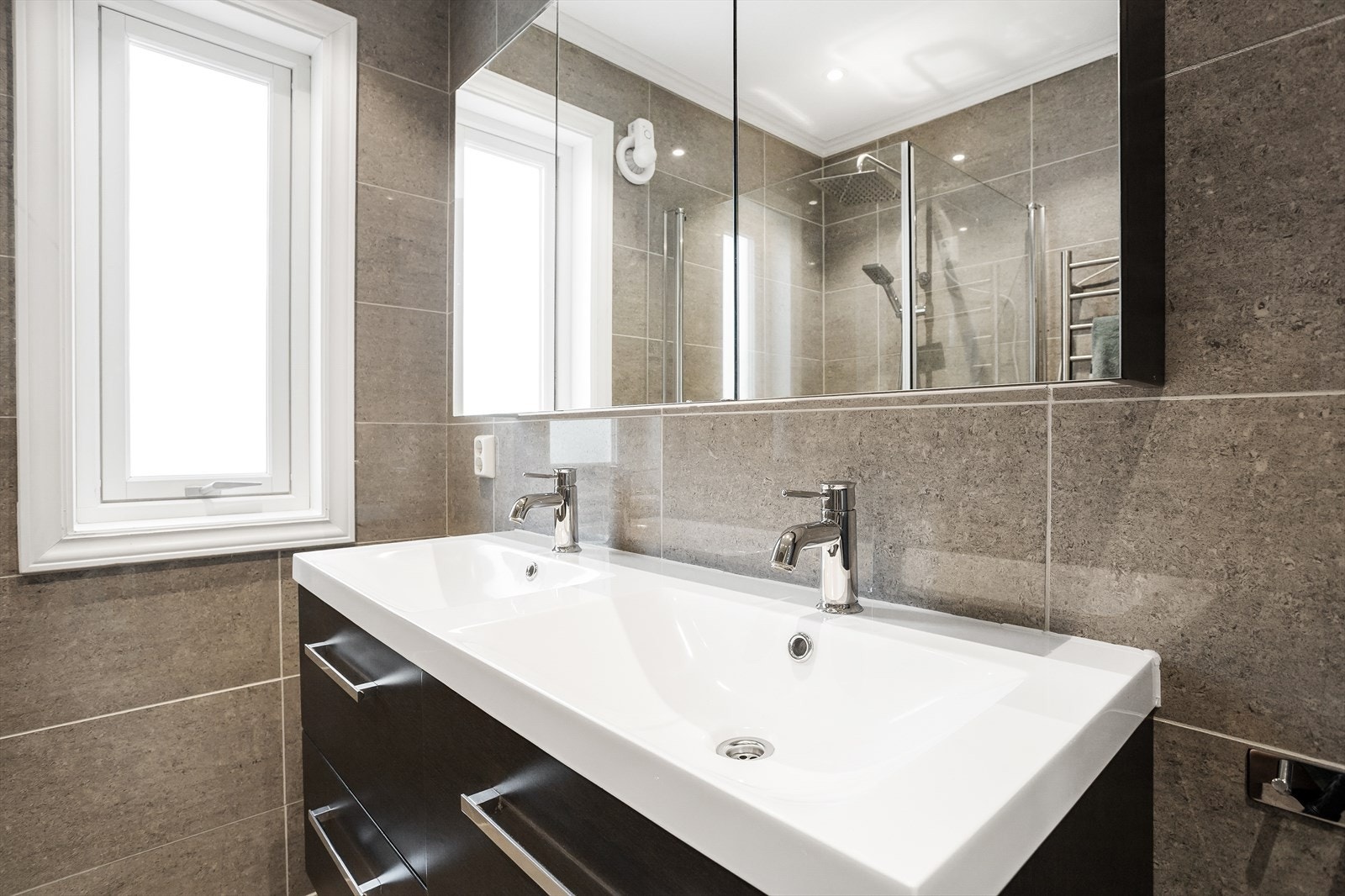 Elegant, helfliset bad med dobbel servant og regnfallsdusj. Galleribilde