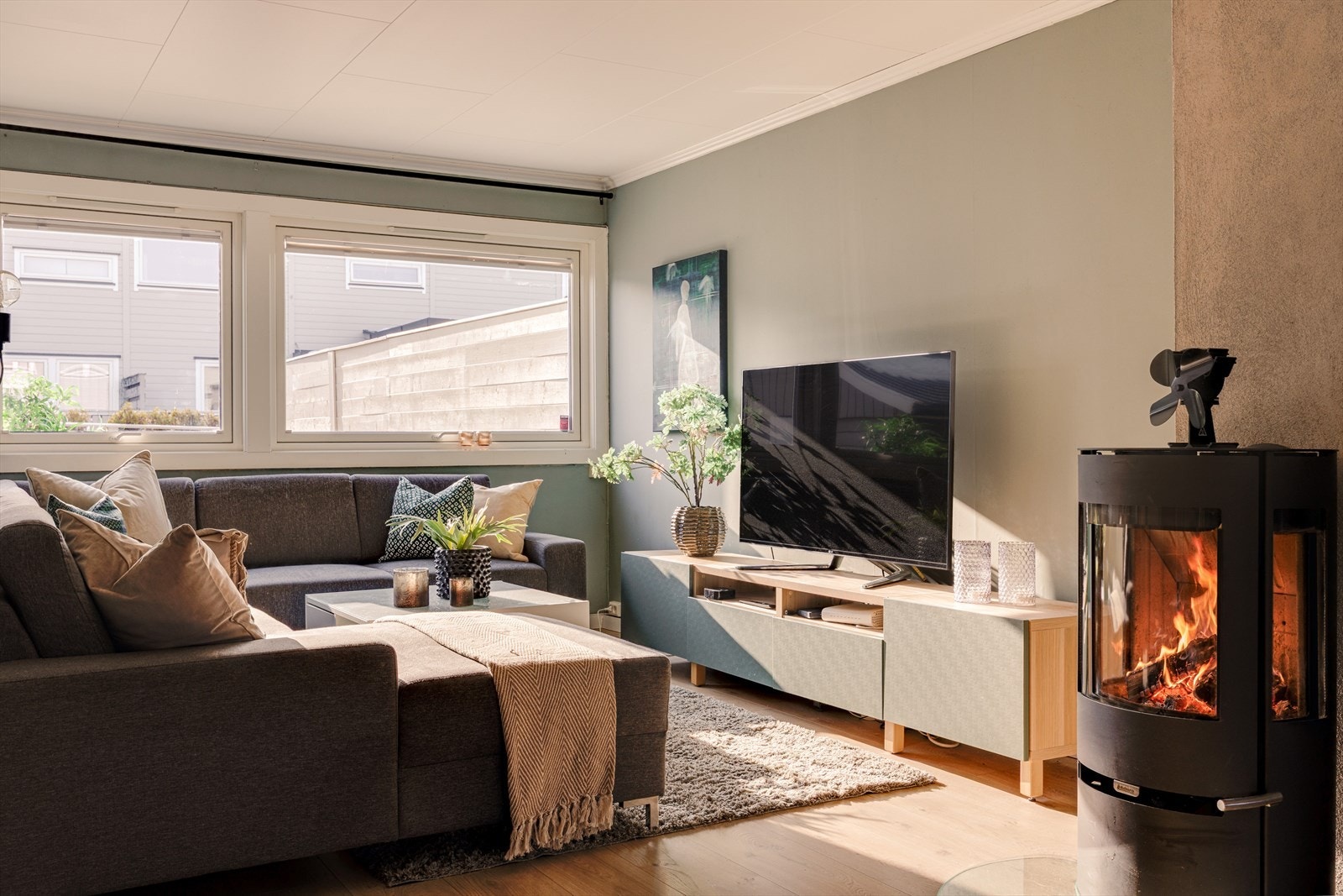 Peisen som er plassert midt i rommet tilfører både varme og atmosfære, samt skaper en lun ramme rundt oppholdsrommet. Galleribilde