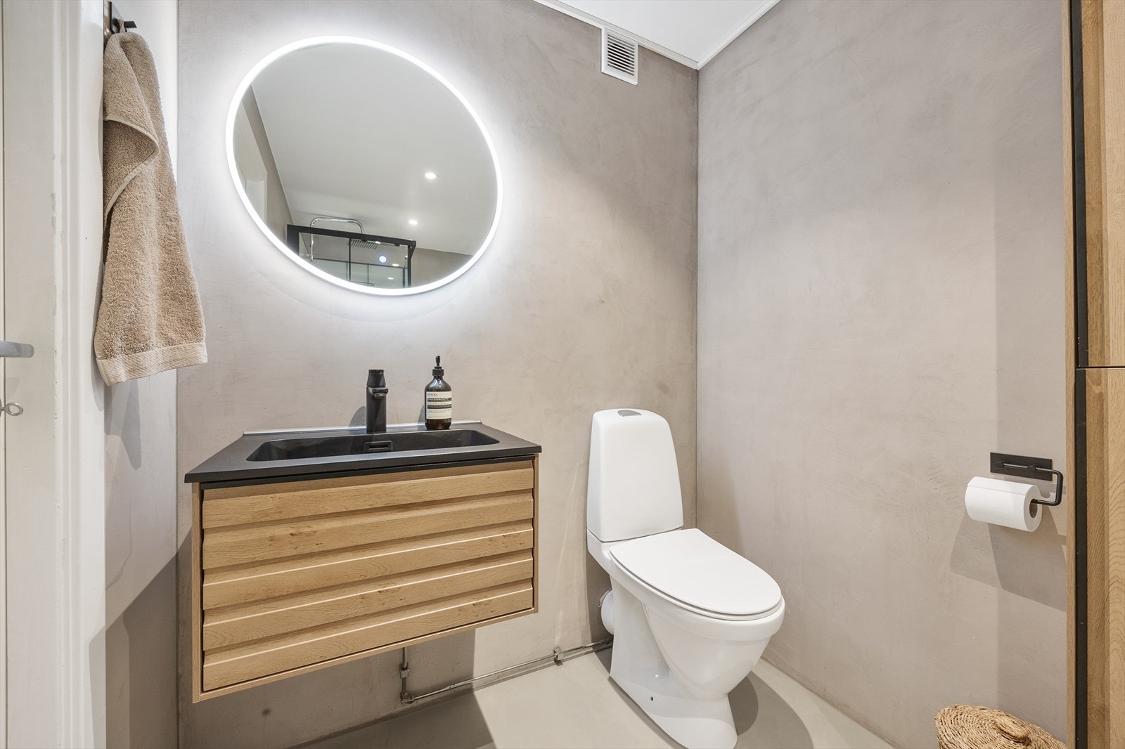 Baderomsinnredning i tre med heldekkende servant og speil med belysning. Galleribilde