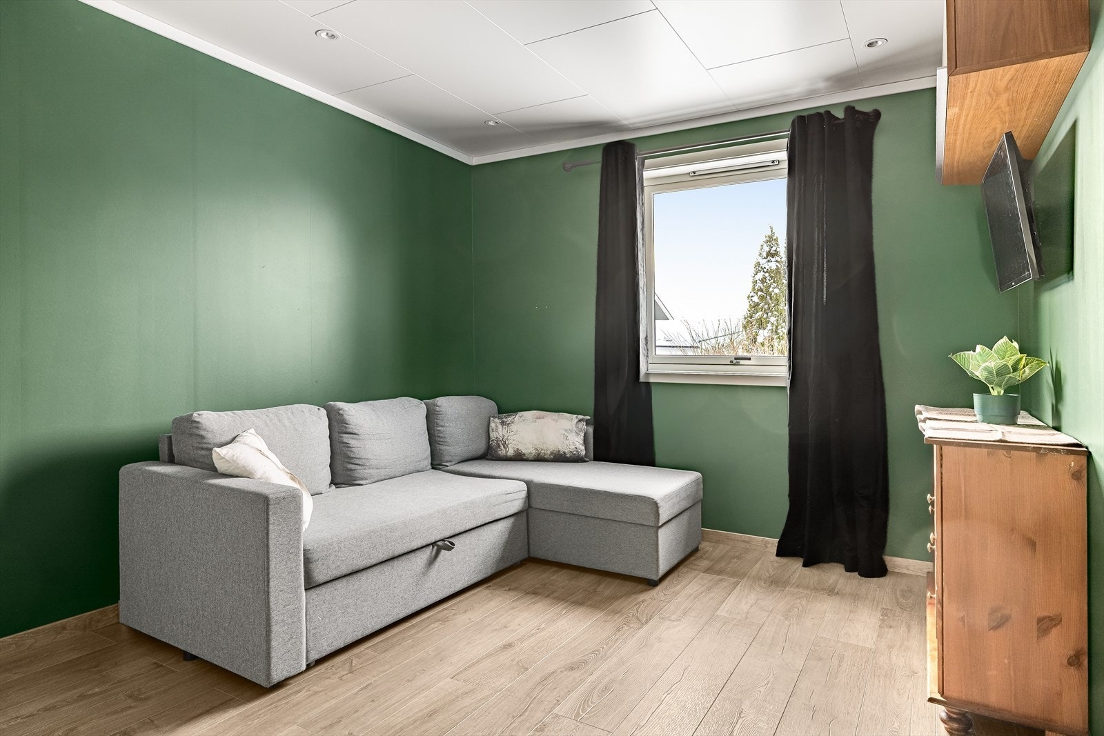 Soverom 1 er i dag innredet som en ekstra stue. Soverommet ble pusset opp i 2021og har god standard med enstavs laminatgulv, malte overflater og innfelte downlights i himlingen. Galleribilde