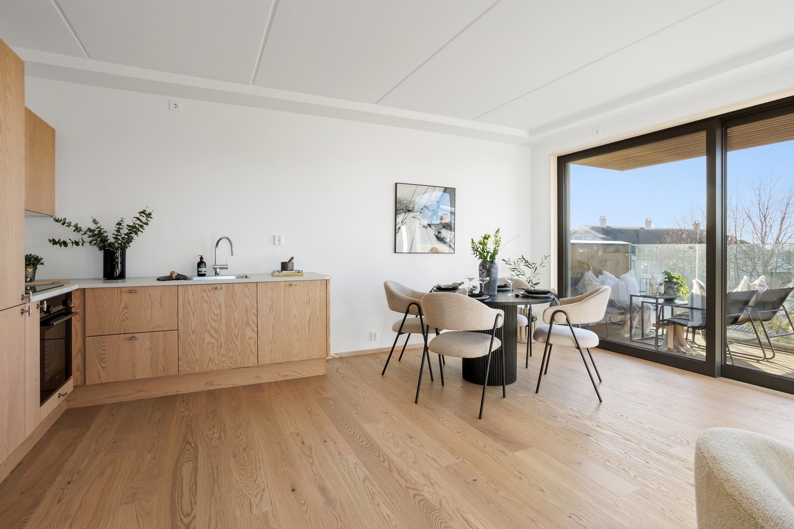 Åpen kjøkkenløsning fra Svane med integrere hvitevarer samt spiseplass. Utgang til vestvendt balkong. Galleribilde