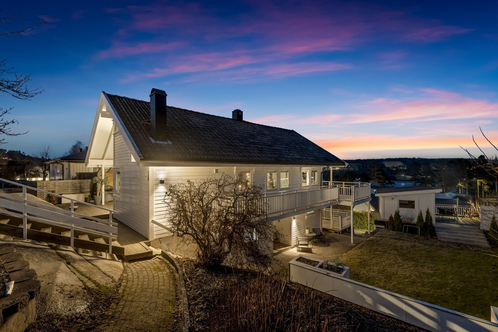 Eiendommen er pent opparbeidet med plen, beplantning og flere terrasser. Galleribilde