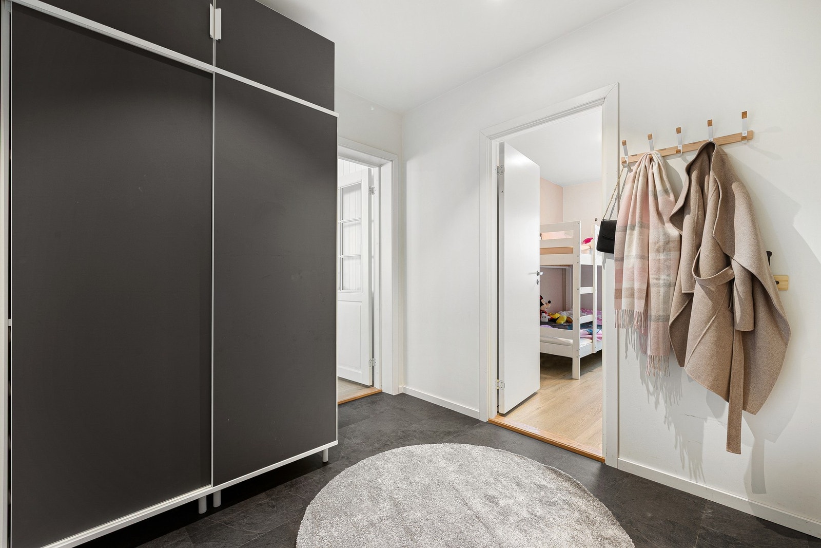 Romslig entré med god oppbevaringsplass i en stor skyvedørsgarderobe. Galleribilde