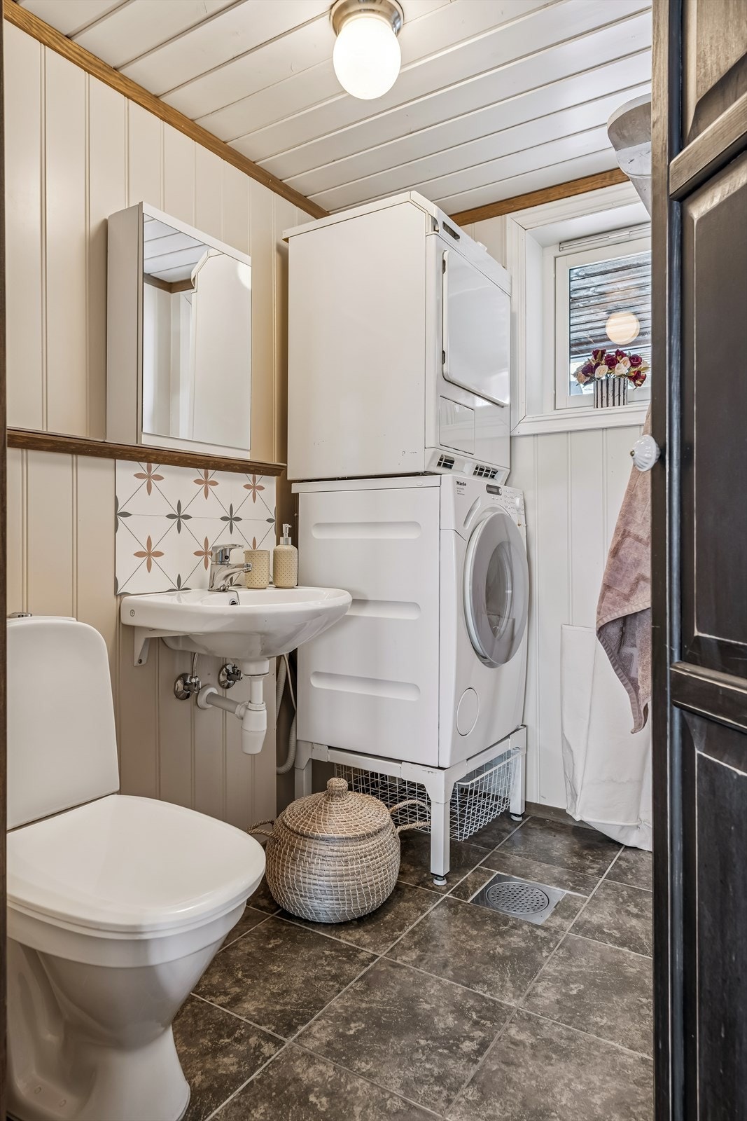 Praktisk vaskerom/toalettrom med flislagt gulv, vannbåren varme og opplegg for vaskemaskin. Galleribilde