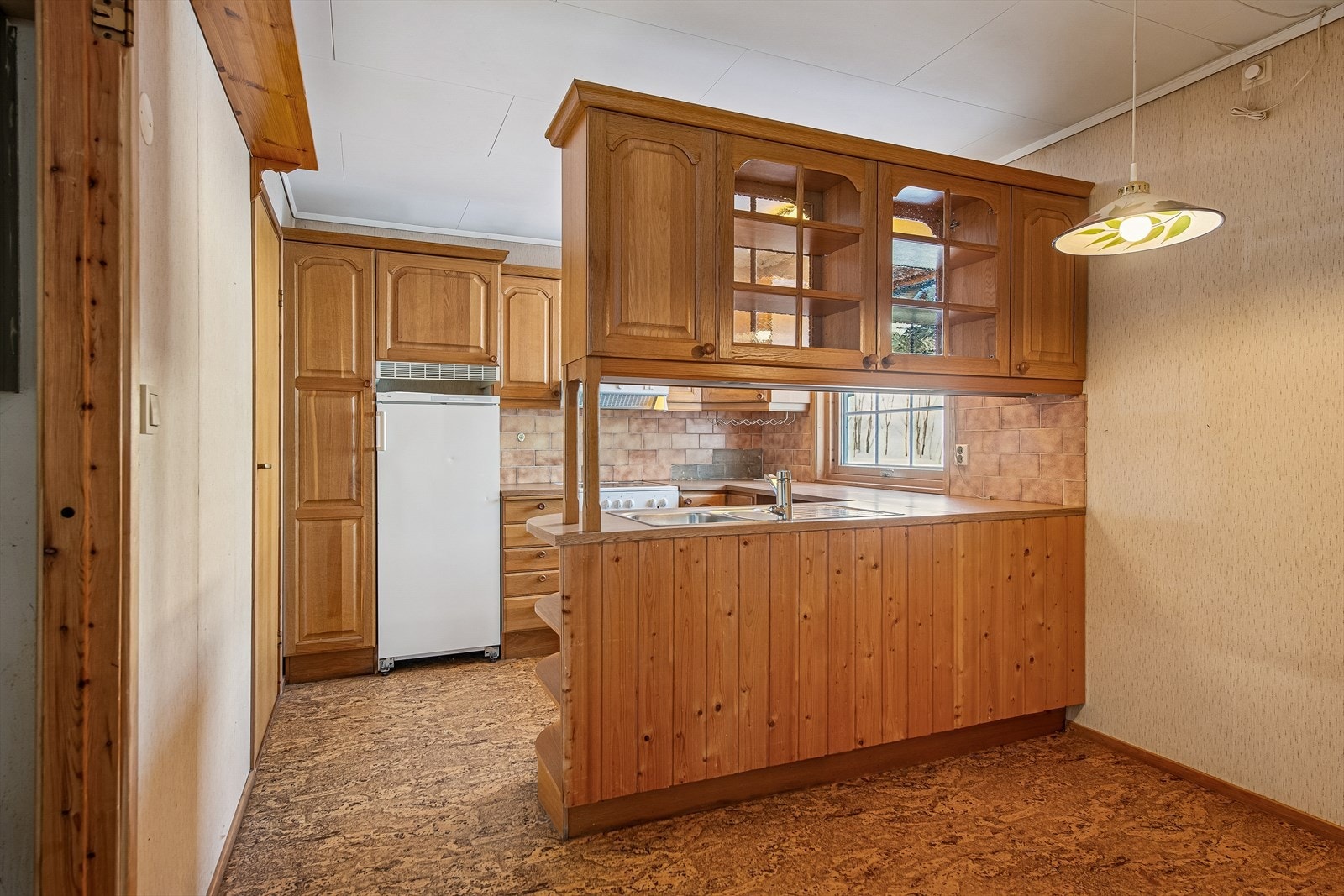 Kjøkkenet har en funksjonell innredning med profilerte fronter og laminert benkeplate. Galleribilde