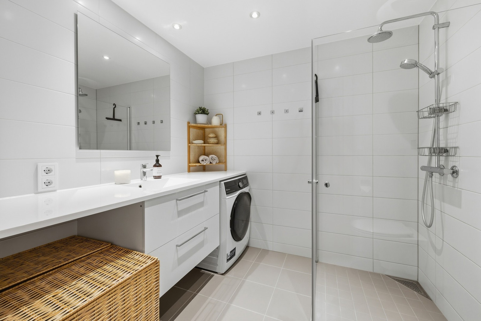 Smakfullt bad fra 2020 med flislagte overflater og varmekabler i gulv. Innredningen består av moderne servantmøbel med to skuffer, speil og vegghengt toalett. Galleribilde