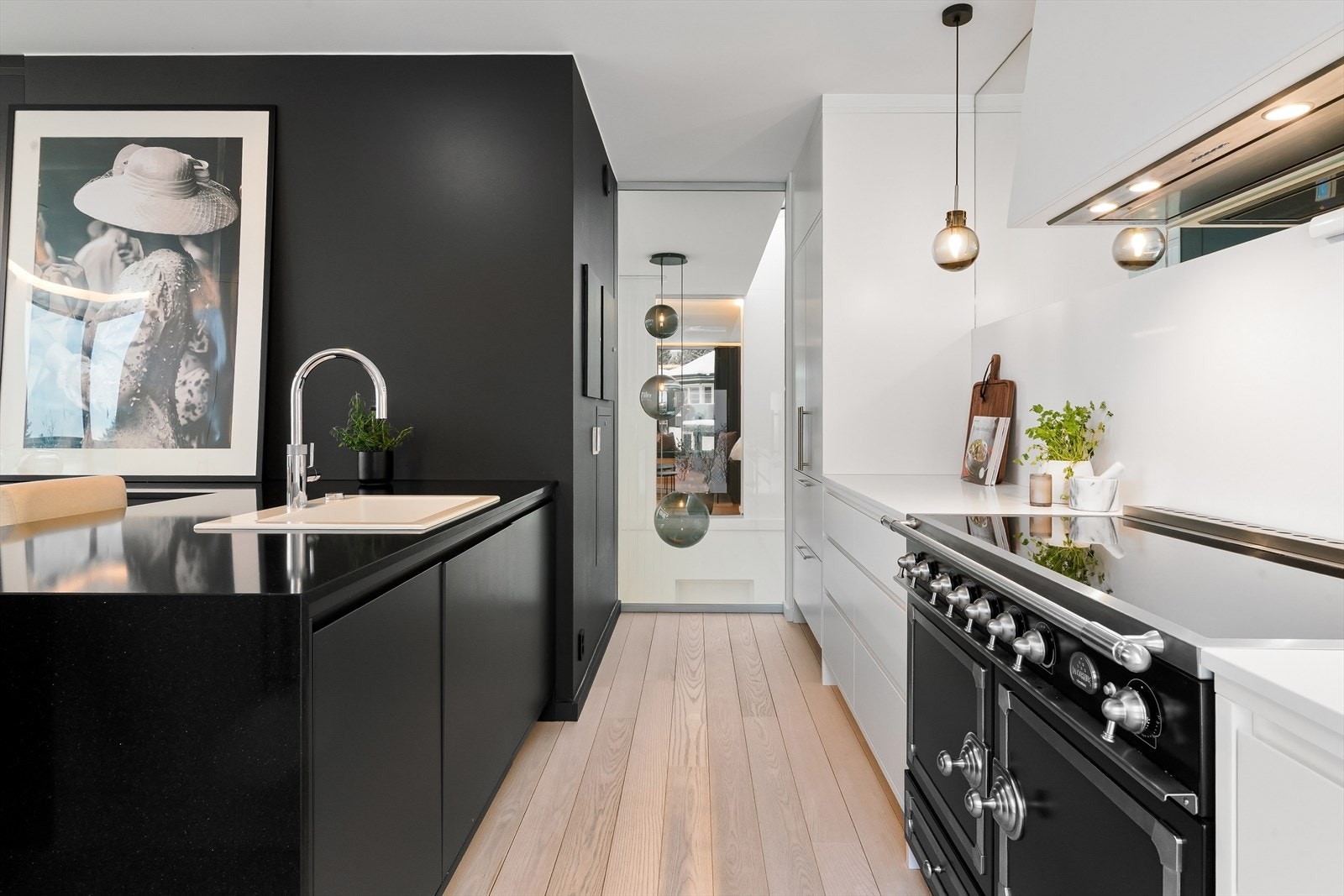 Kjøkkeninnredning tegnet av interiørarkitekt og levert fra Wisewood med polert benkeplate, to-fløyet kjøleskap, 2 fryseskuffer, vinskap og oppvaskmaskin. Galleribilde