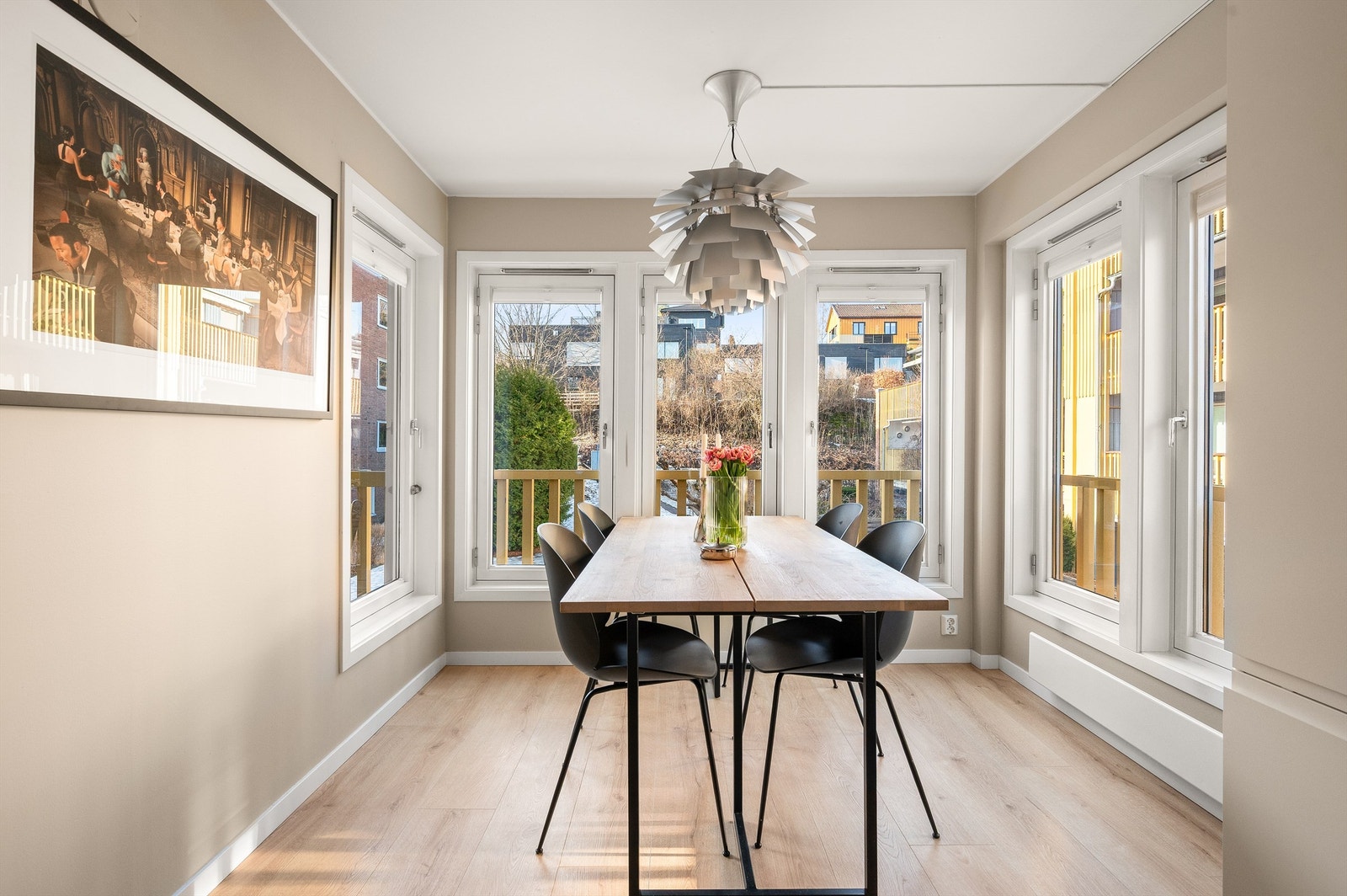 Spisestuen er plassert i et lyst hjørne med vinduer som slipper inn rikelig med dagslys. Galleribilde