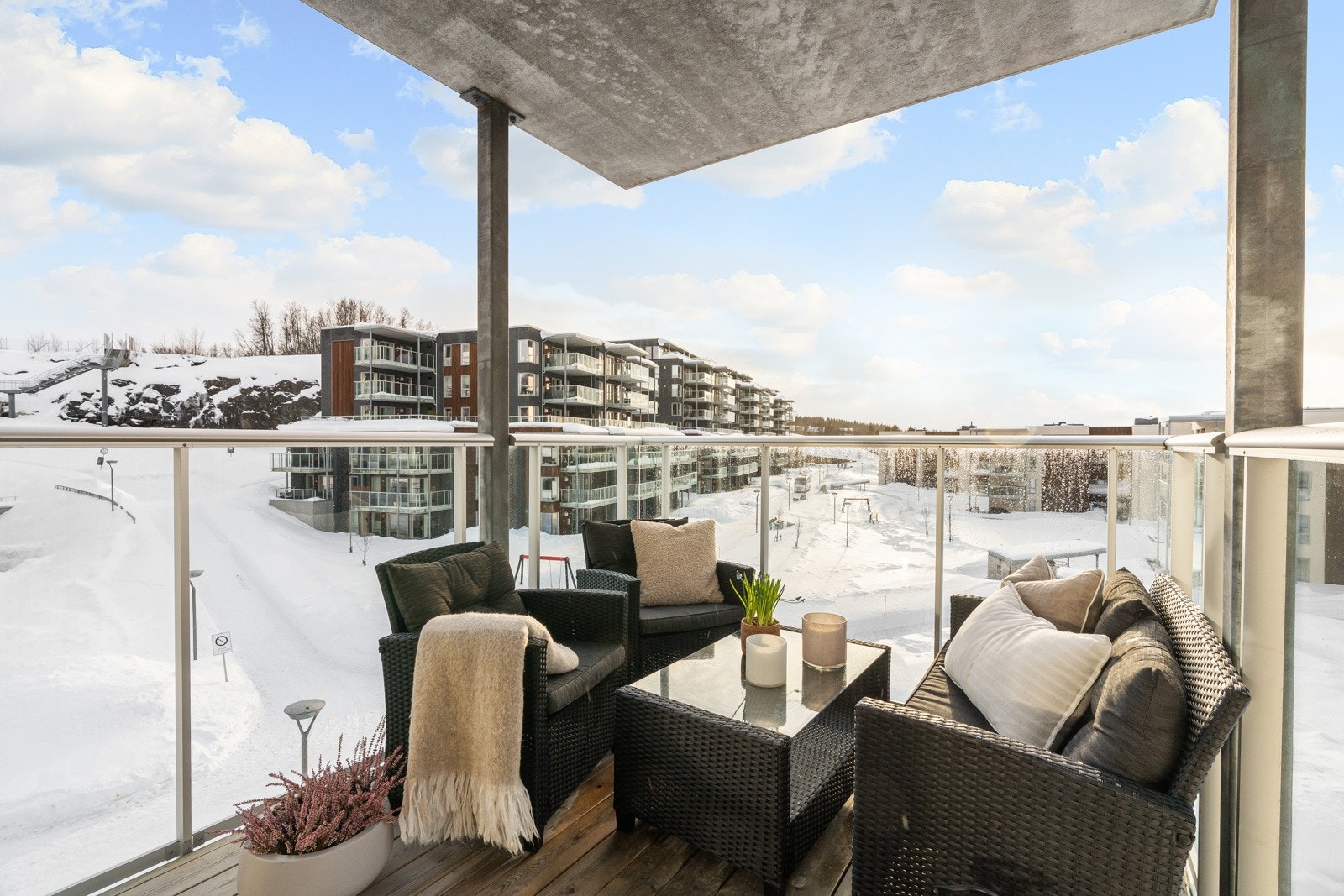 Balkongen er overbygd og har god plass for utemøbler, noe som gir høy bruksverdi.