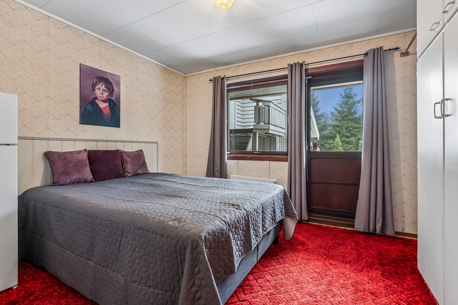 Ett av soverommene har plassbygde garderobeskap og utgang til en luftebalkong. Galleribilde