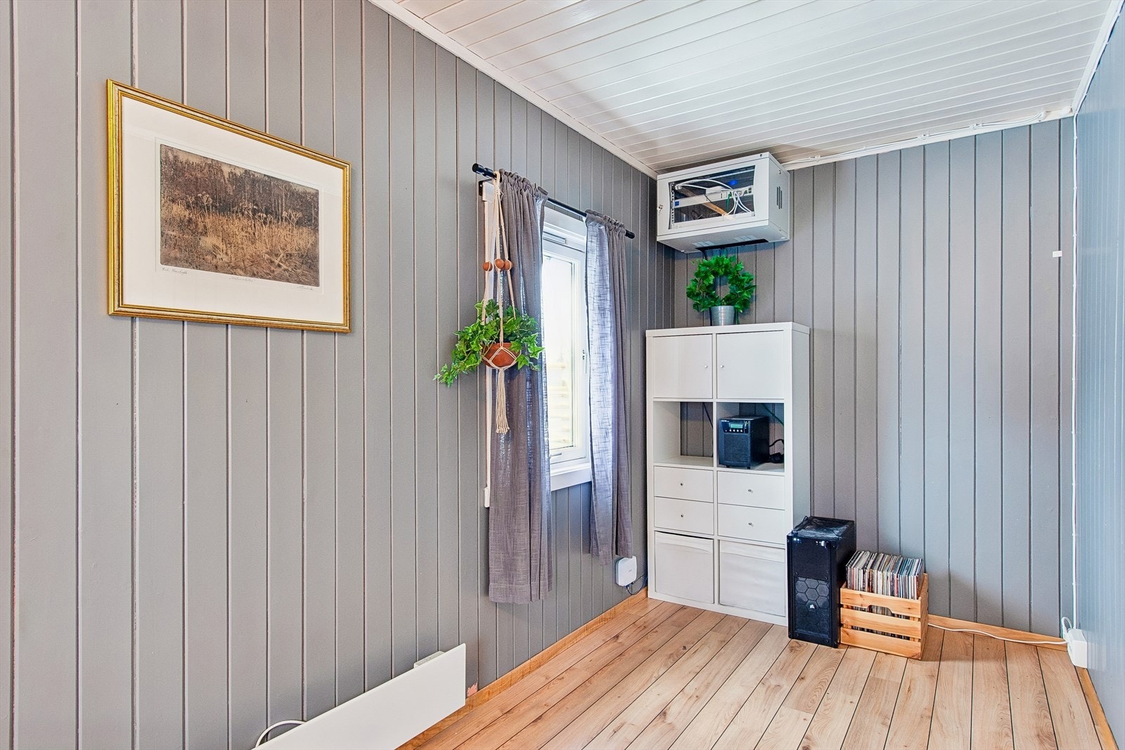 Rommet har malte panelplater på veggene og plass til garderobeløsninger. Galleribilde