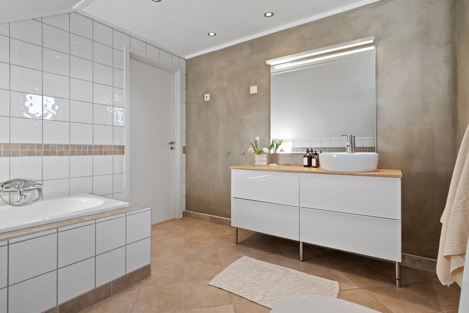 Badet har god størrelse og er utstyrt med innfliset badekar med dusjløsning. Galleribilde