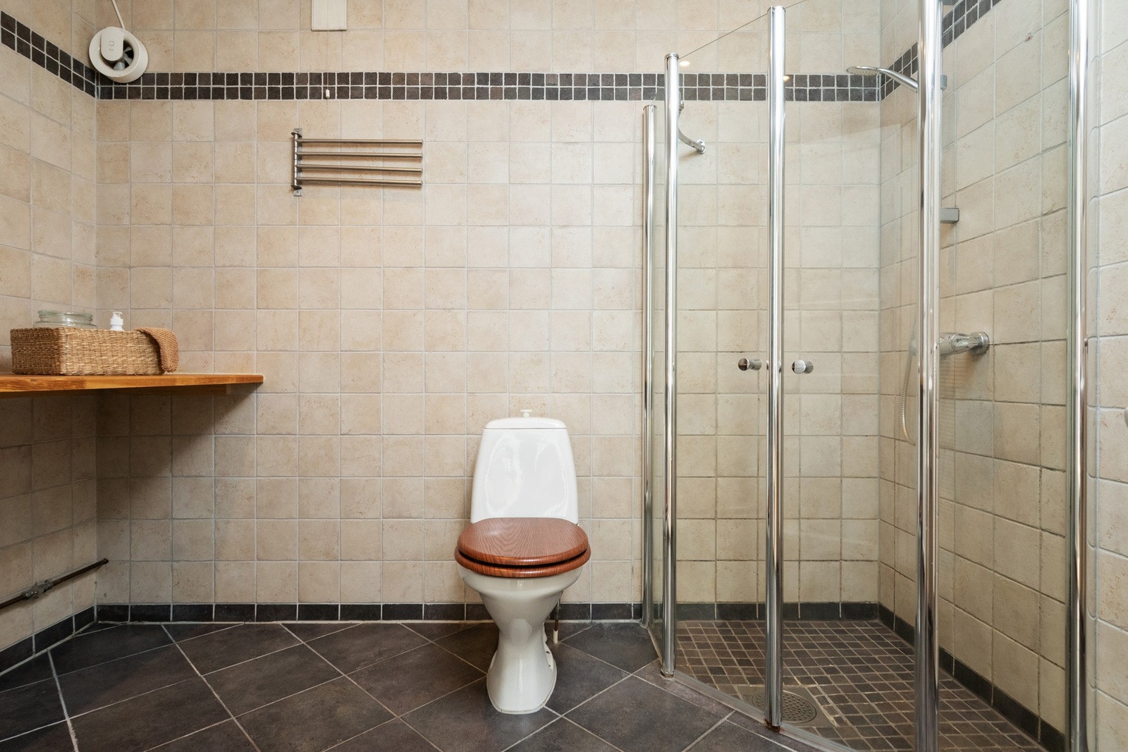 Badet i underetasjen er helfliset og er utstyrt med toalett, dusjhjørne med glassdører, gulvvarme og downlights. Galleribilde