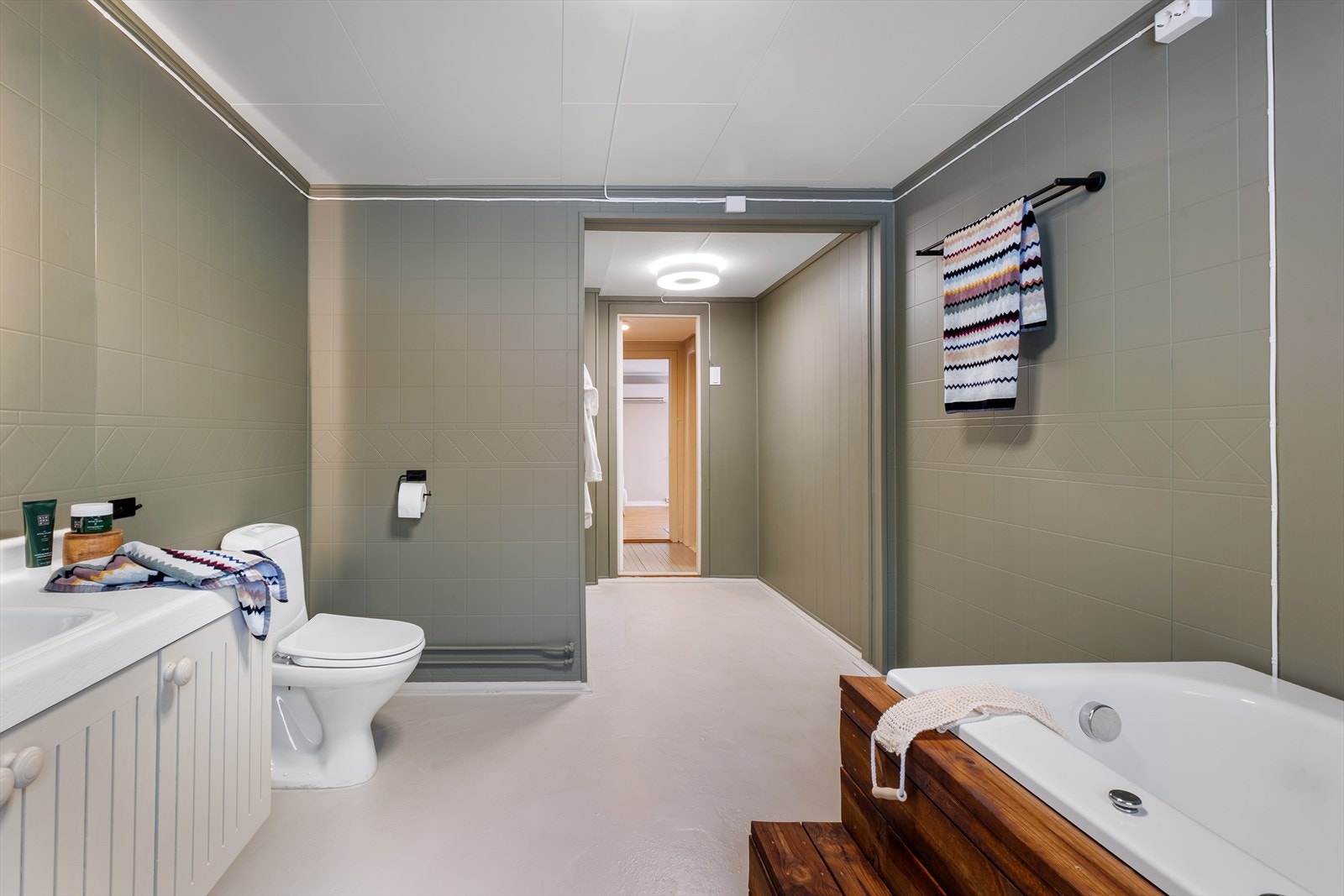 Badet er utført med vinylbelegg m/varmekabler på gulv og vegger med tapet/belegg Galleribilde