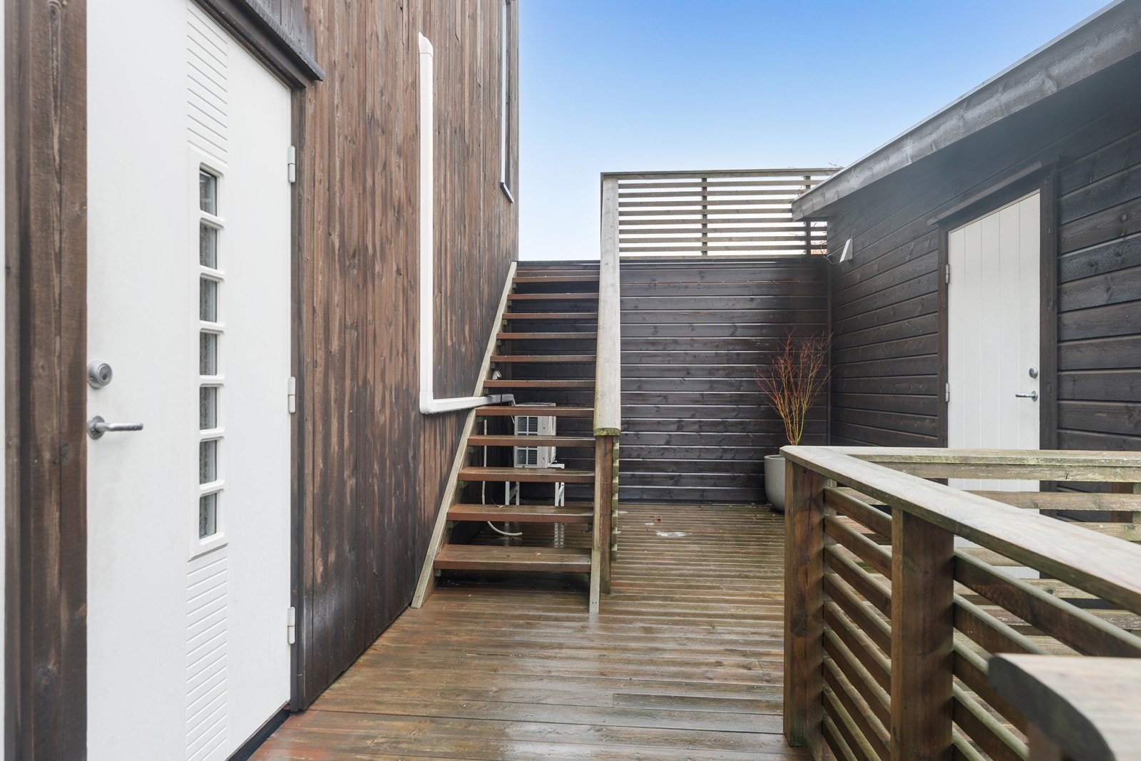 Trappeoppgang i forlengelse av inngangspartiet fører opp til hageområdet. Utvendig bod til høyre. Galleribilde