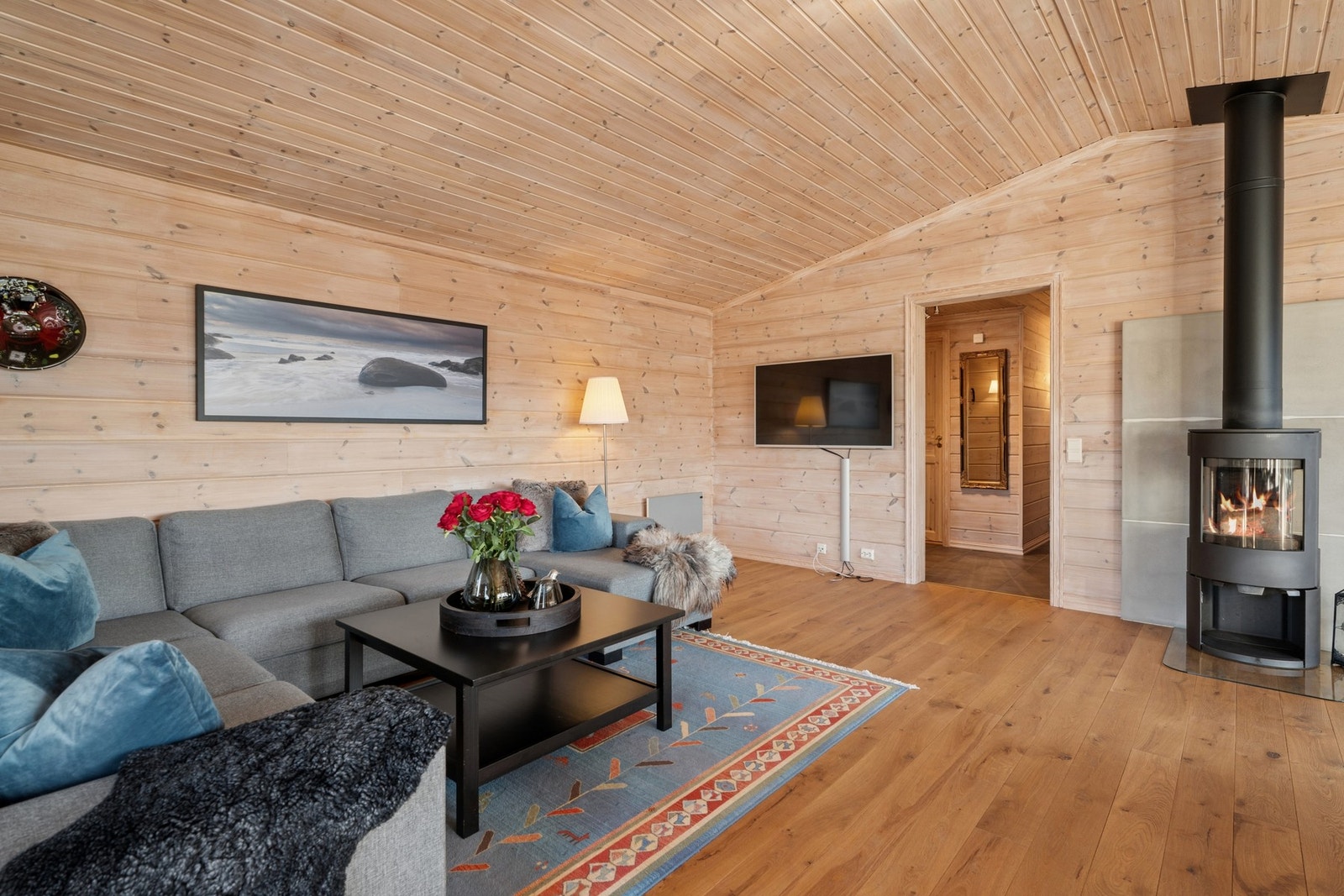 - I stuen står det en vedovn som gir god varme til rommet - Galleribilde