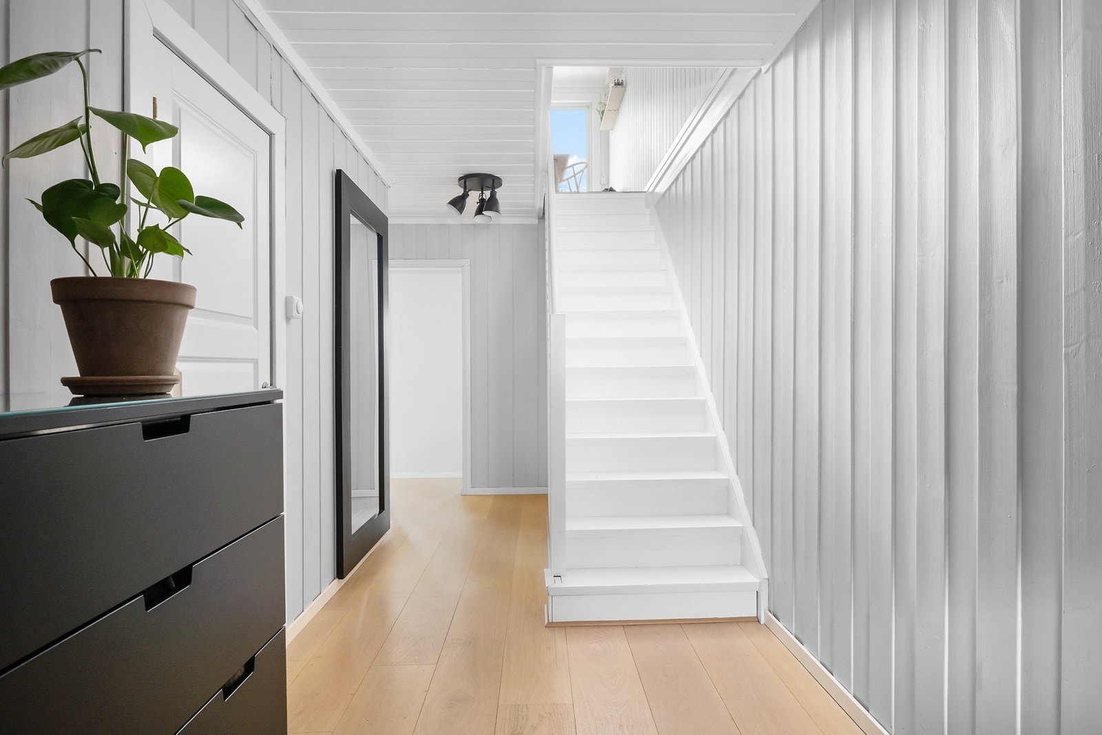 Overflater i boligen består av parkett, vegg-til-vegg teppe og fliser på gulv samt malte flater og malt panel på vegger Galleribilde