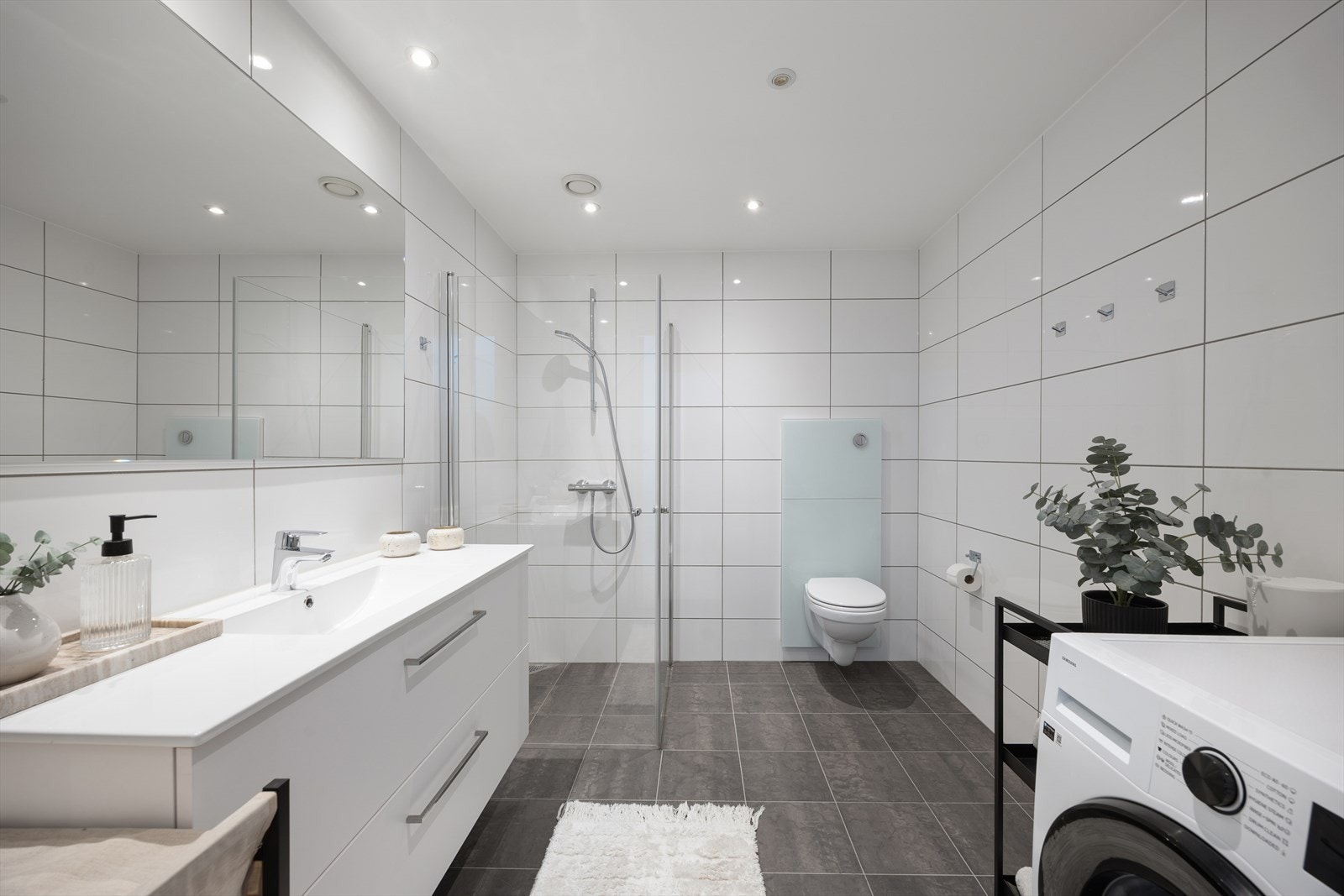 Lyst og pent bad fra 2022 med flislagte overflater Galleribilde