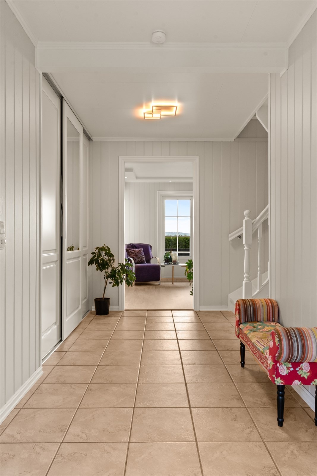 Stig på ! Flislagt gang med praktisk skyvedørsgarderobe, lyst og innbydende ! Galleribilde