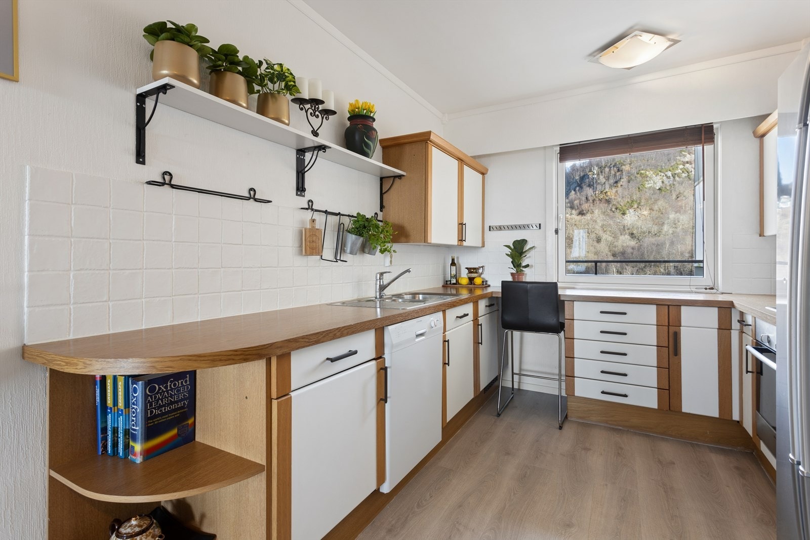 Kjøkkenet er innredet med laminatbenkeplate og nedfelt stålvask, samt integrert stekeovn og oppvaskmaskin. Galleribilde